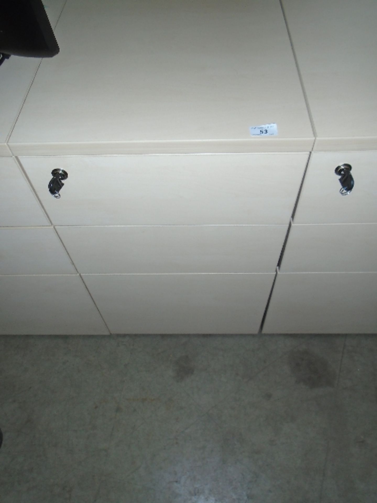 A maple finish three drawer pedestal (keys)