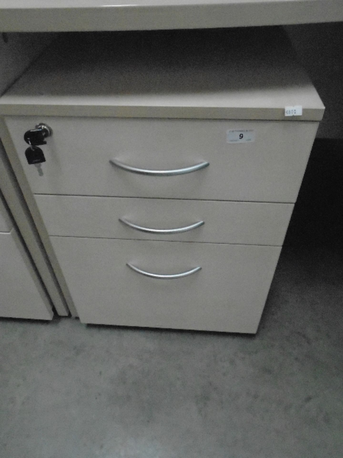 A maple finish three drawer pedestal (keys)