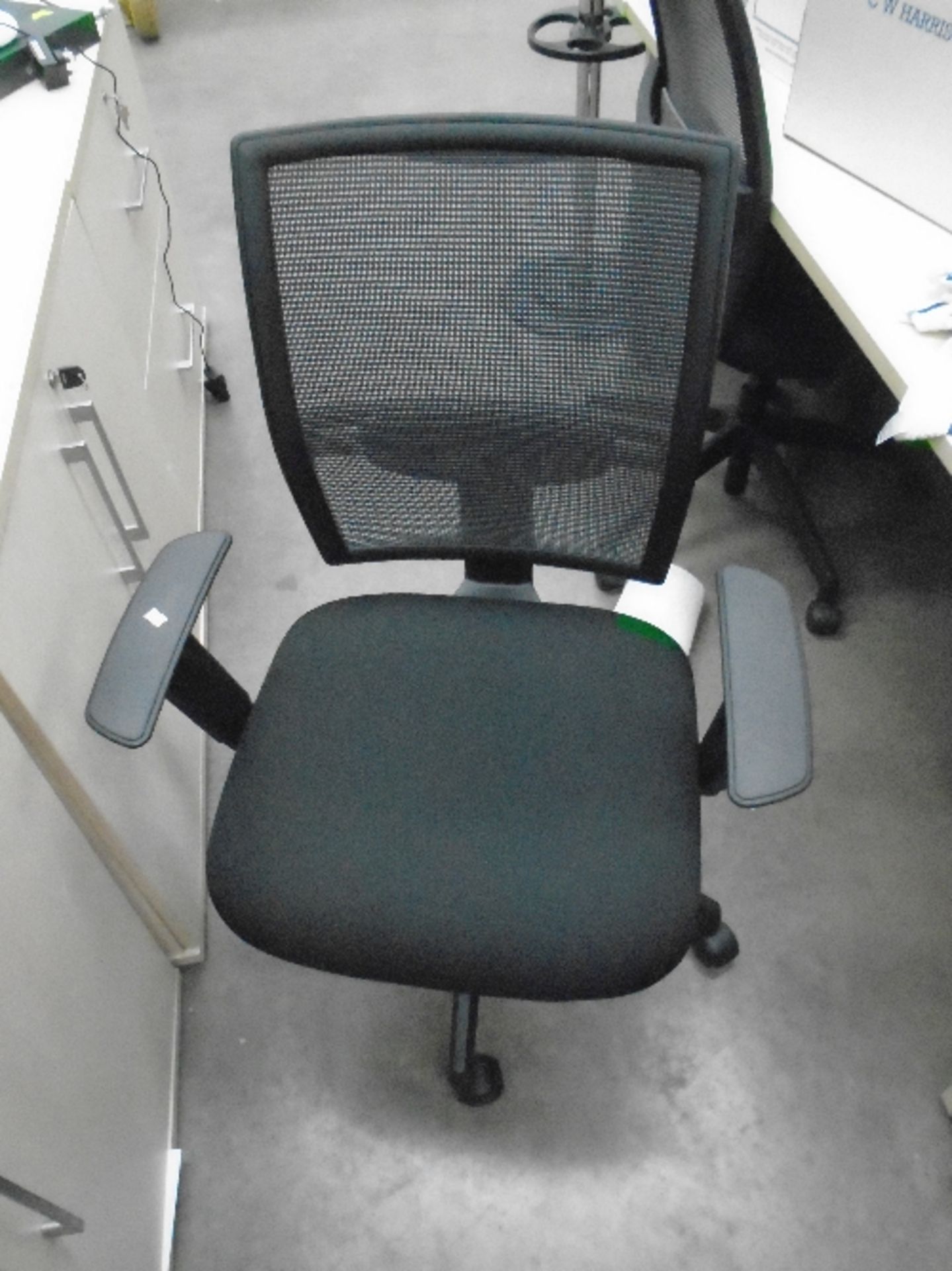 A Vector black upholstered operators swivel arm chair with netted back support