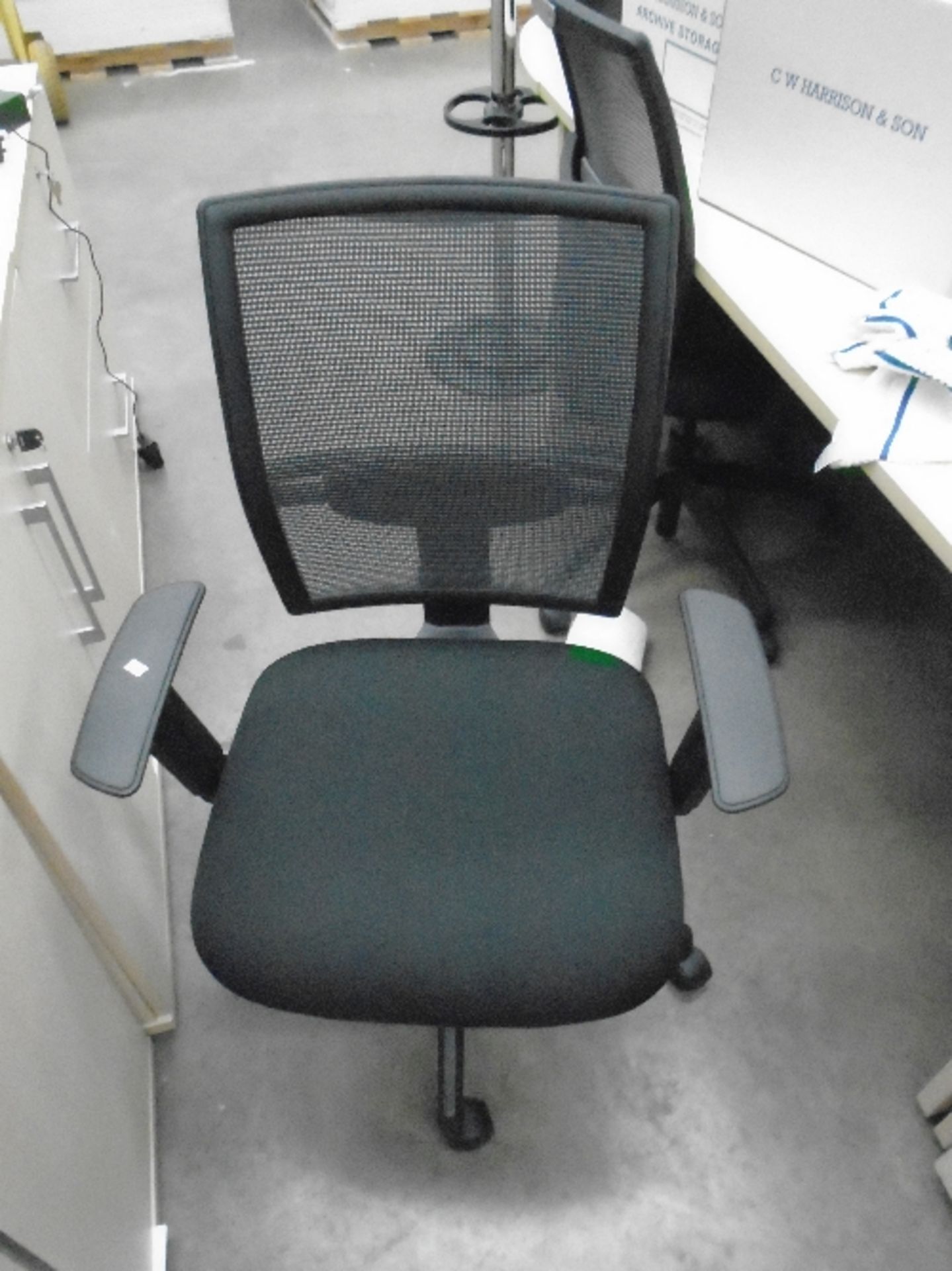 A Vector black upholstered operators swivel arm chair with netted back support