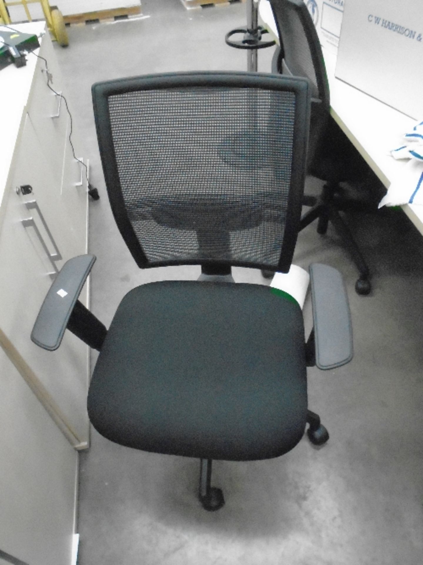 A Vector black upholstered operators swivel arm chair with netted back support