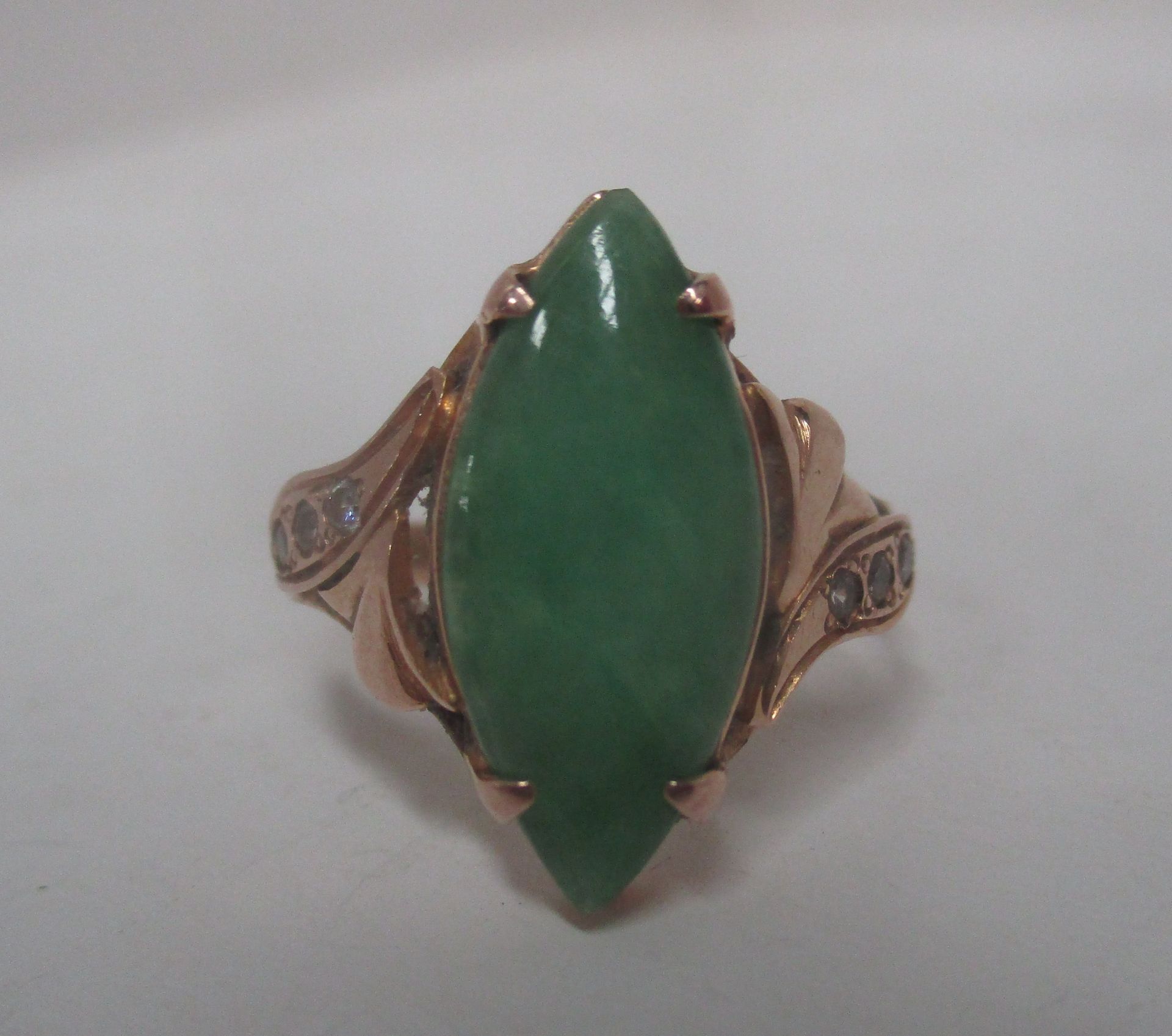 An 18ct yellow gold ring (unstamped) set with a large marquise shaped jade