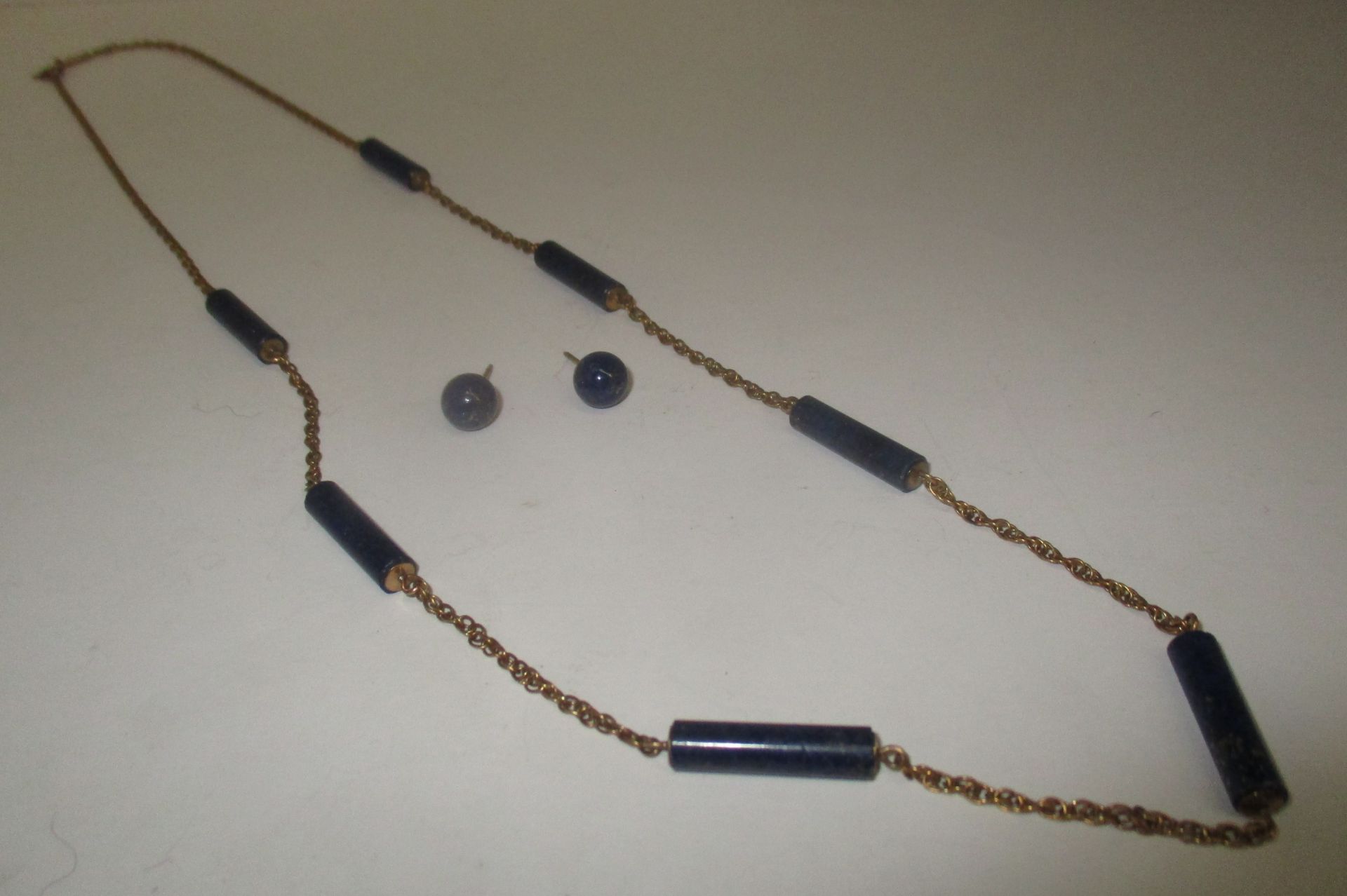 A necklace of seven cylinders of real untreated Lapis Lazuli joined by a heavy 9ct gold Prince of