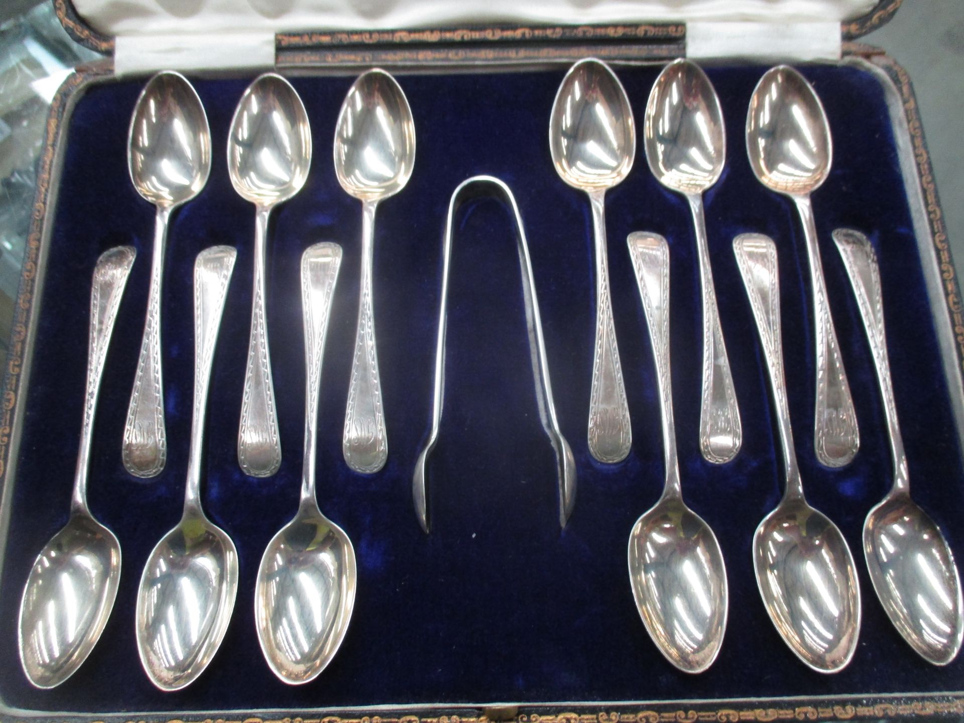 12 x silver teaspoons and a pair of silver sugar tongs