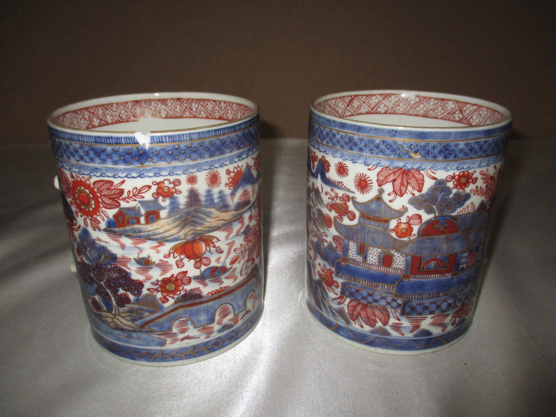 A pair of Imari patterned jugs (handles missing - as seen)