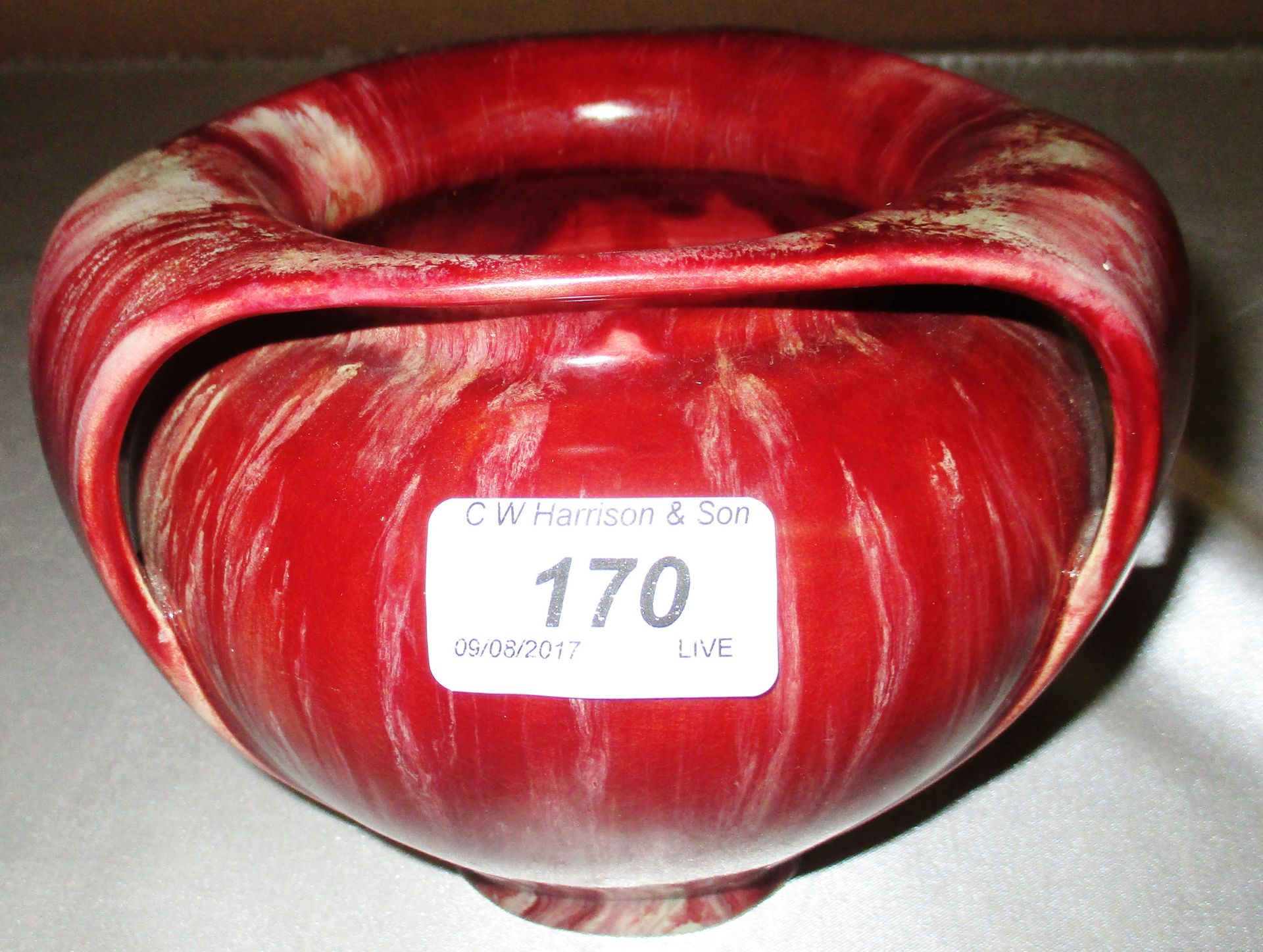 An Art Nouveau pottery tyg jug with a red glaze - manufacturers mark to the base Further