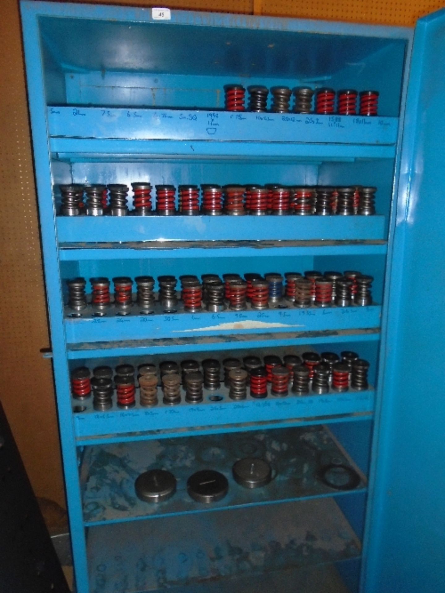 A blue metal single door storage cabinet 89 x 180cm complete with a quantity of metal press die