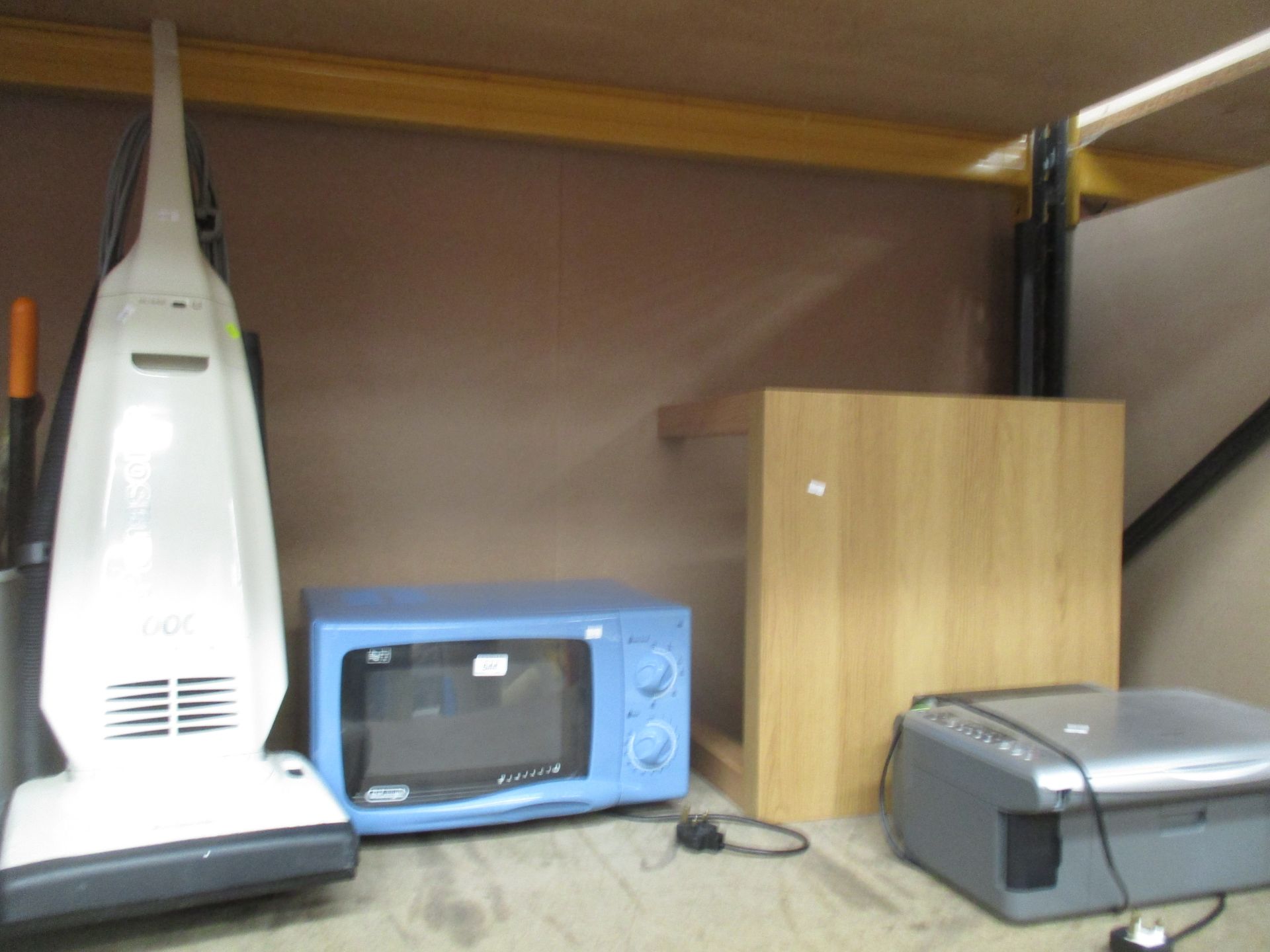 A Panasonic 1000w upright vacuum cleaner, a Delonghi microwave, oak finish coffee table and an Epson