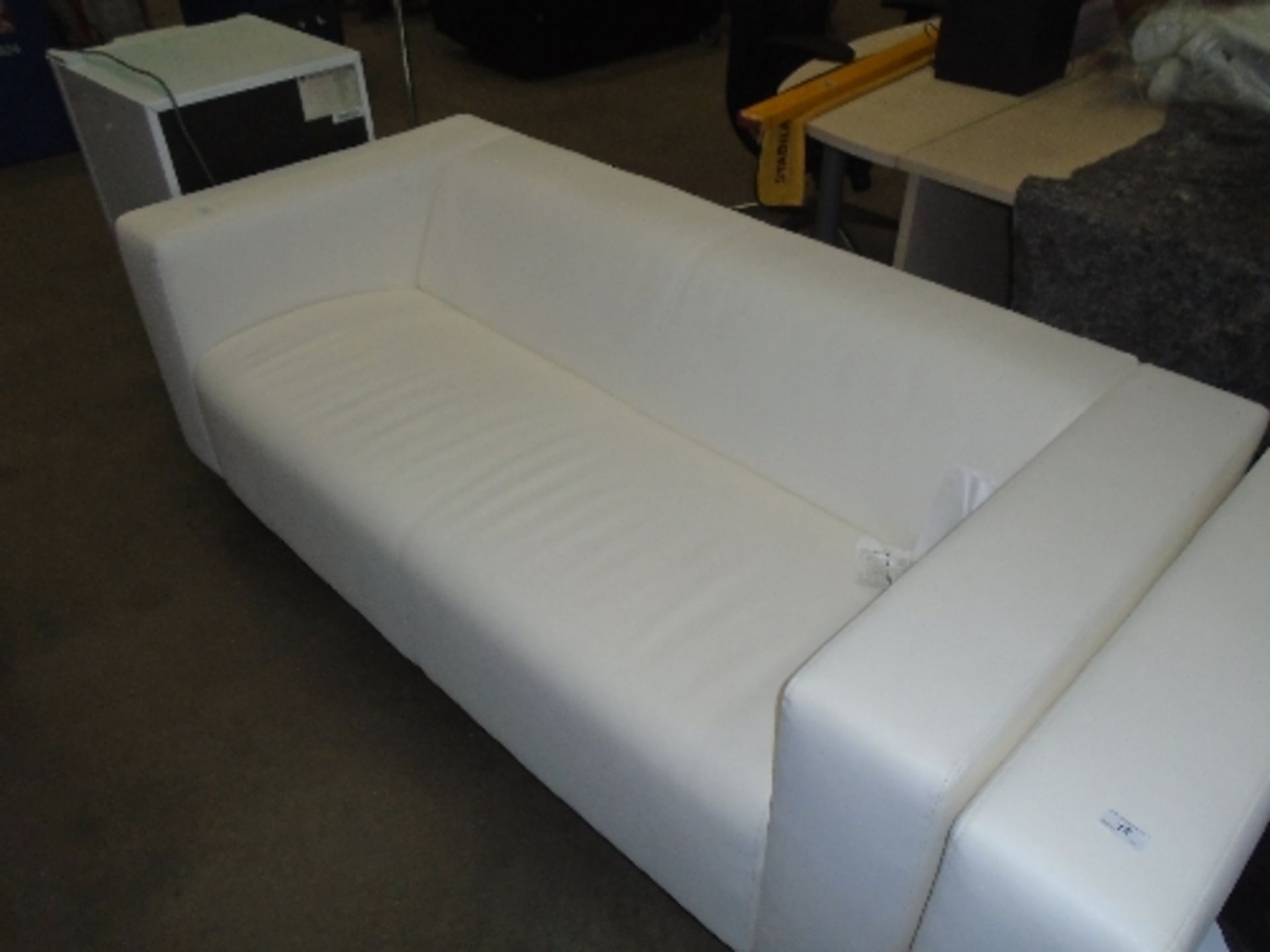 An Ikea white leather finish three seater settee on metal feet