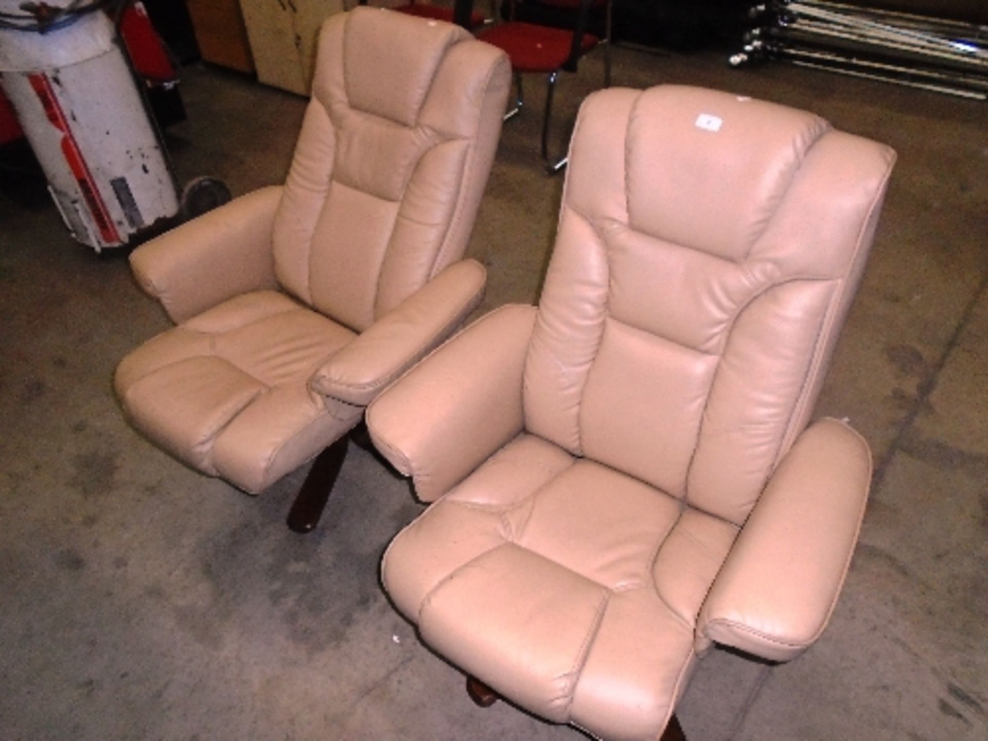 A pair of Julian Brown P10709D beige leather recliner lounger chairs on wooden splayed legs