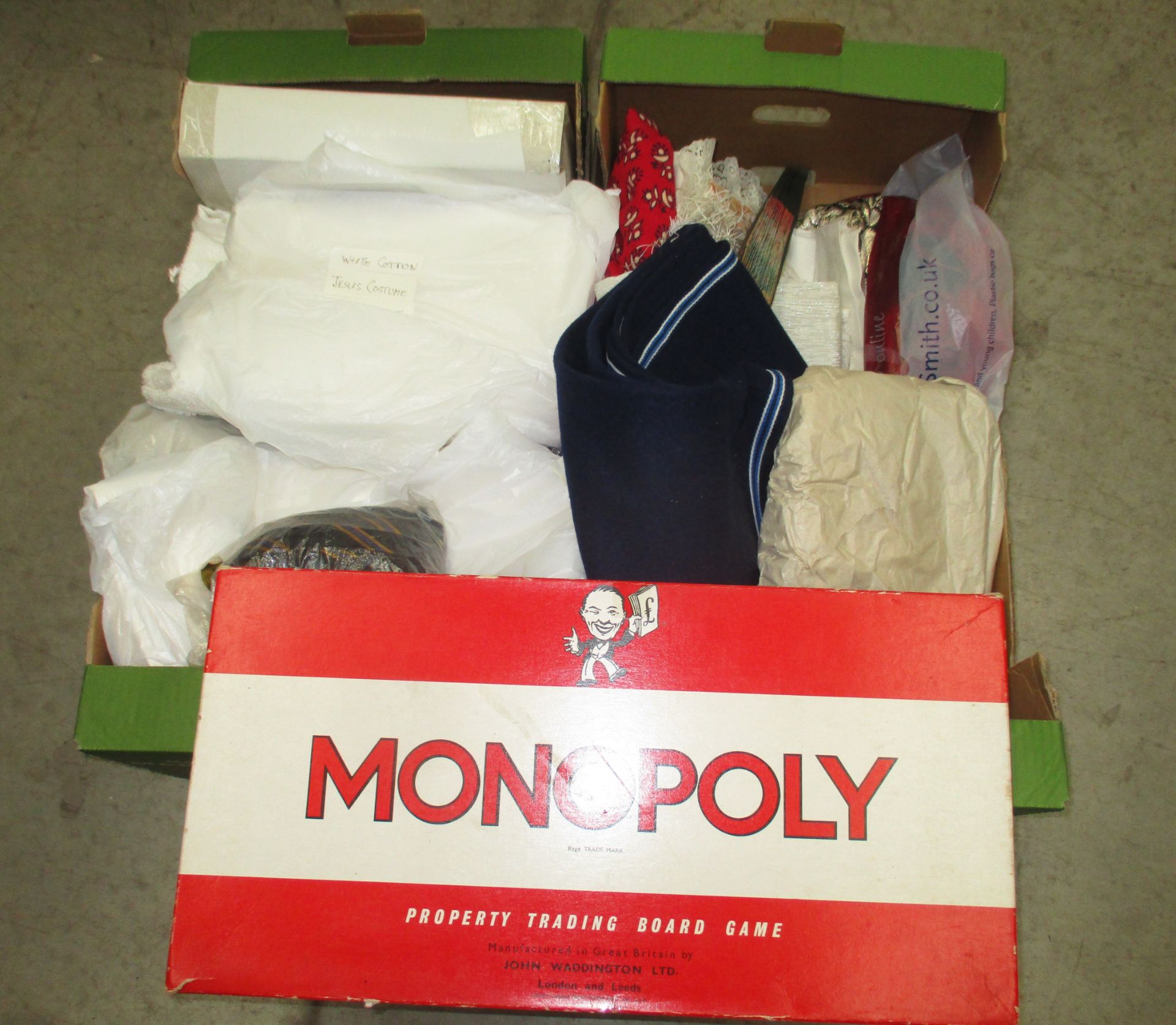 Contents to two boxes - quantity of assorted linen, cloths etc., a Monopoly board game, etc.