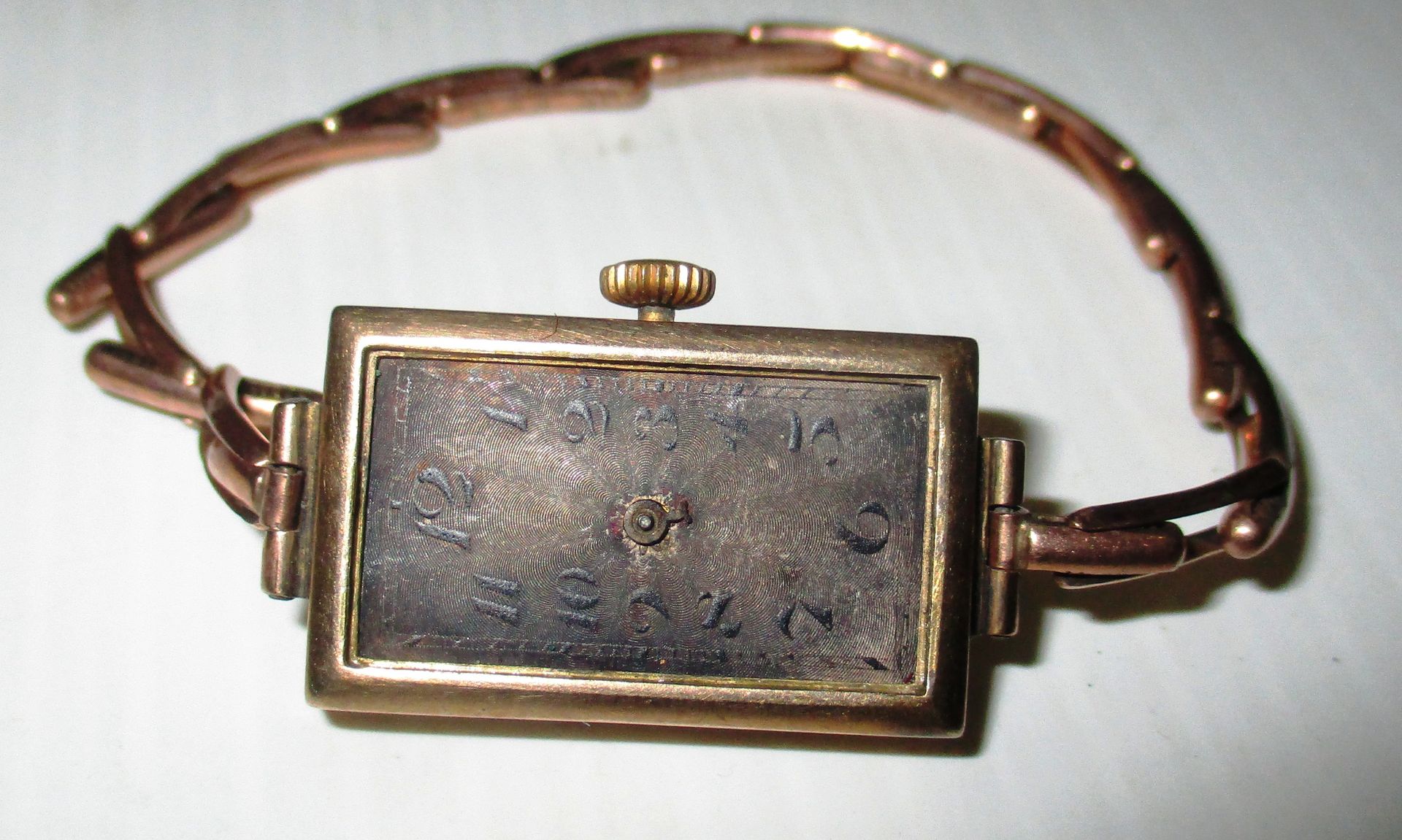 A ladies wristwatch with 9ct gold case and 9ct gold expanding bracelet (watch as seen - no hands)