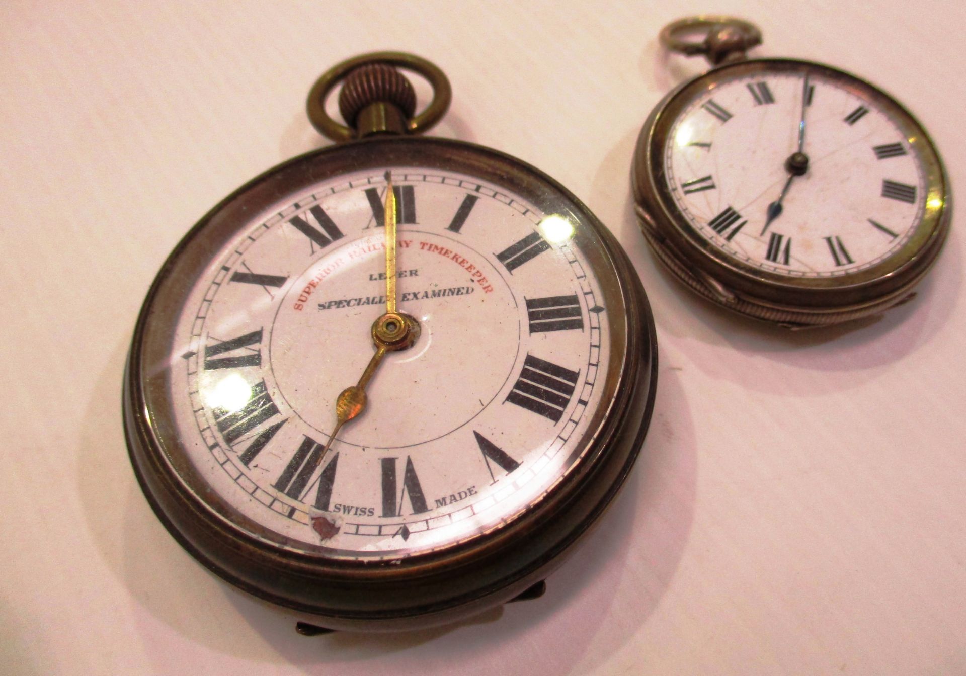 A Superior Railway Timekeeper pocket watch and a small pocket watch