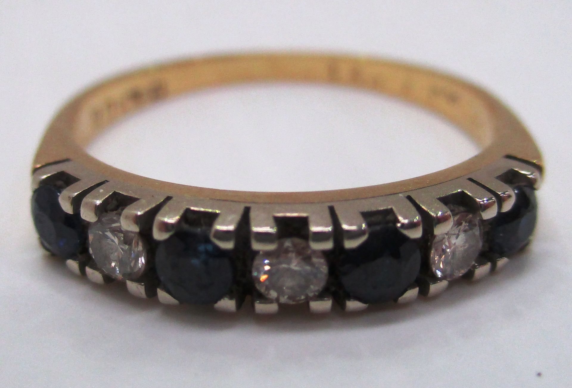 An 18ct gold half hoop eternity ring set with sapphires and diamonds (total approx weight 2.