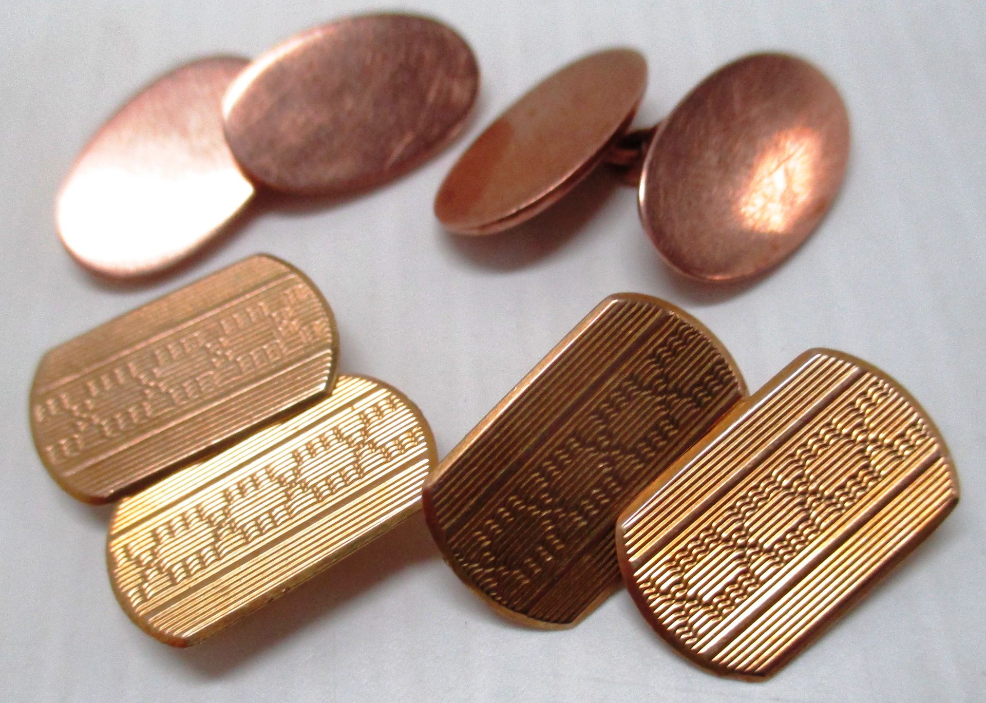 A pair of 9ct gold cuff links and another pair of cuff links