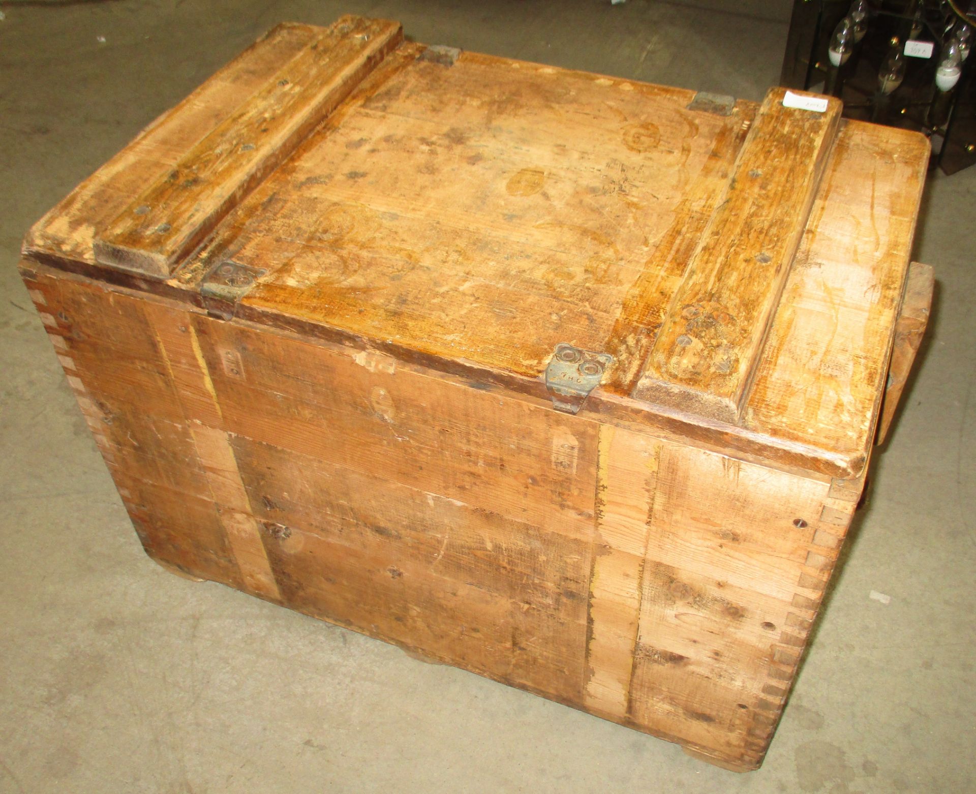 A wooden crate with lift top lid