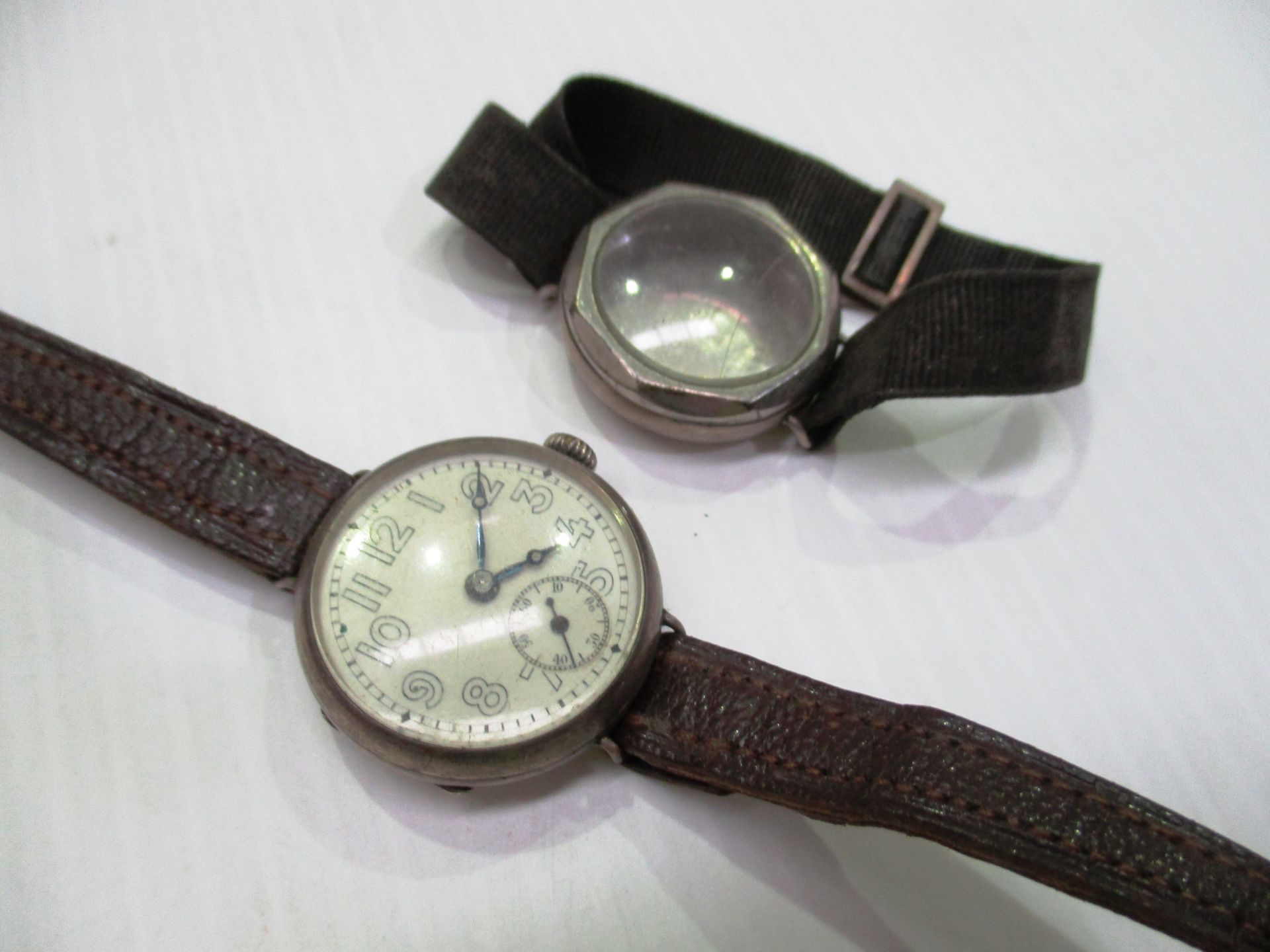 A gents silver cased wristwatch with brown leather strap and a gents silver wristwatch case (no