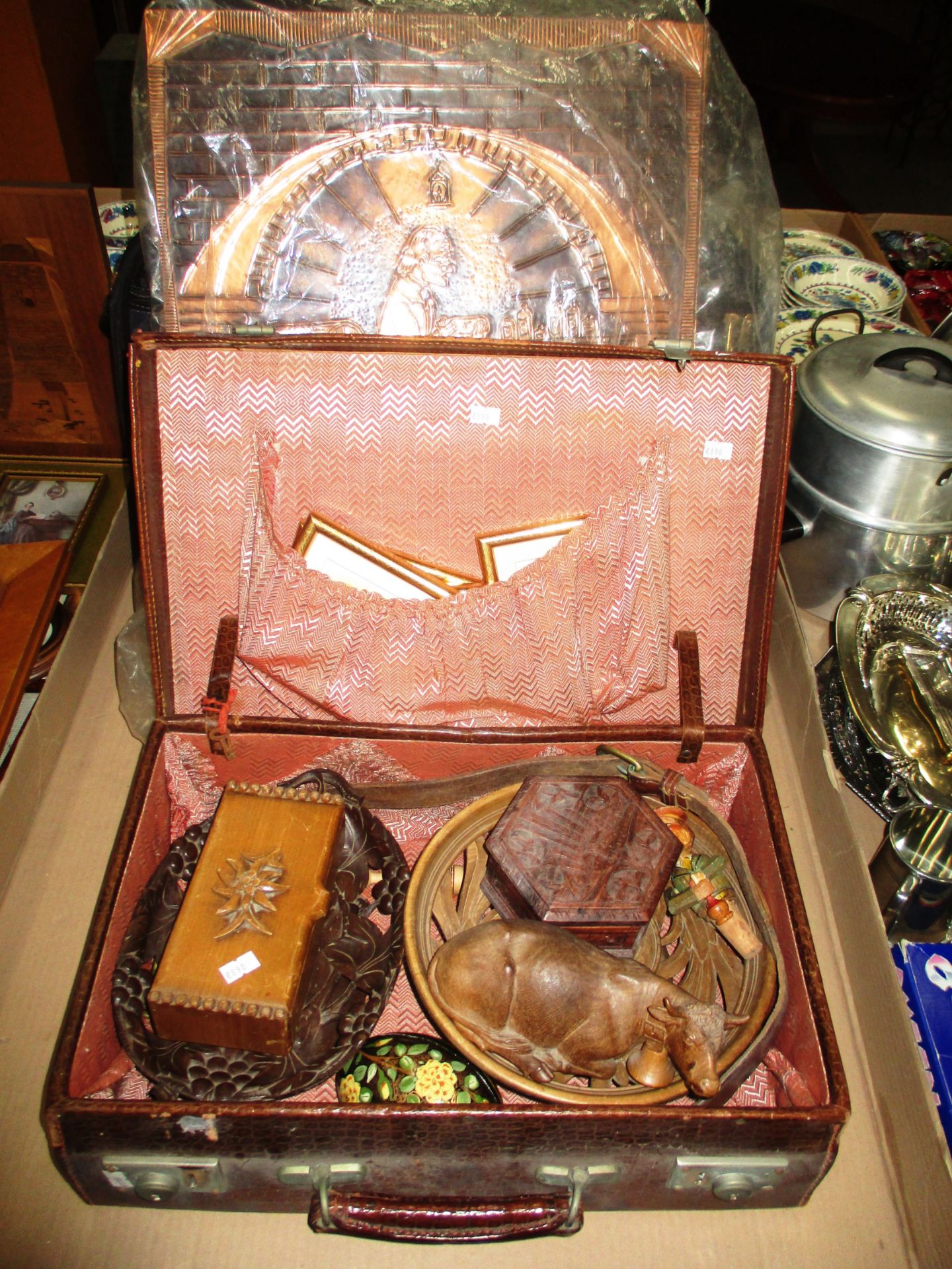 A brown leather suitcase, two carved wooden musical stands, musical box, carved wooden figurine,