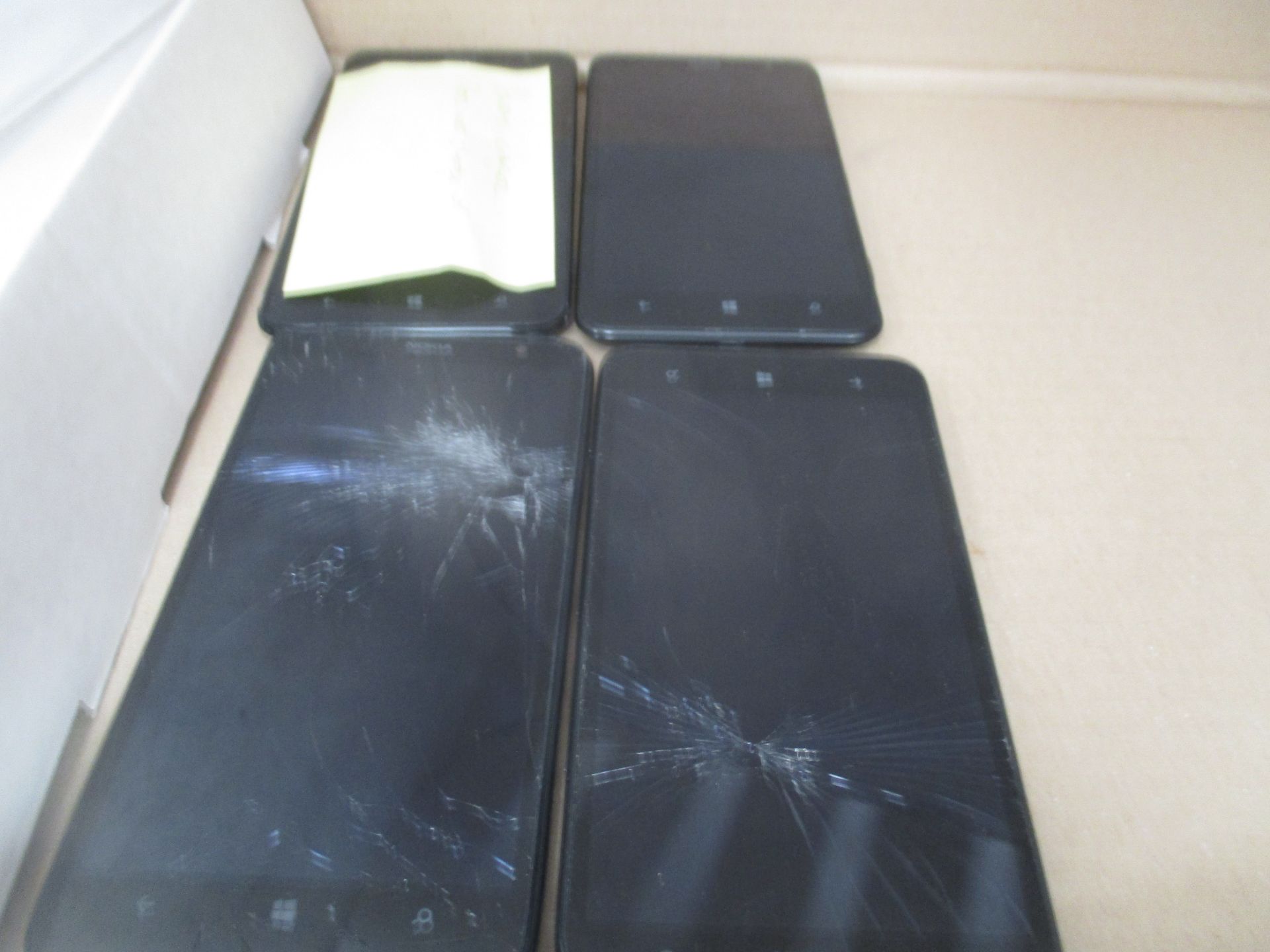 4 x Microsoft 1320 mobile phones (no chargers) - Please Note: 4 x cracked screens,