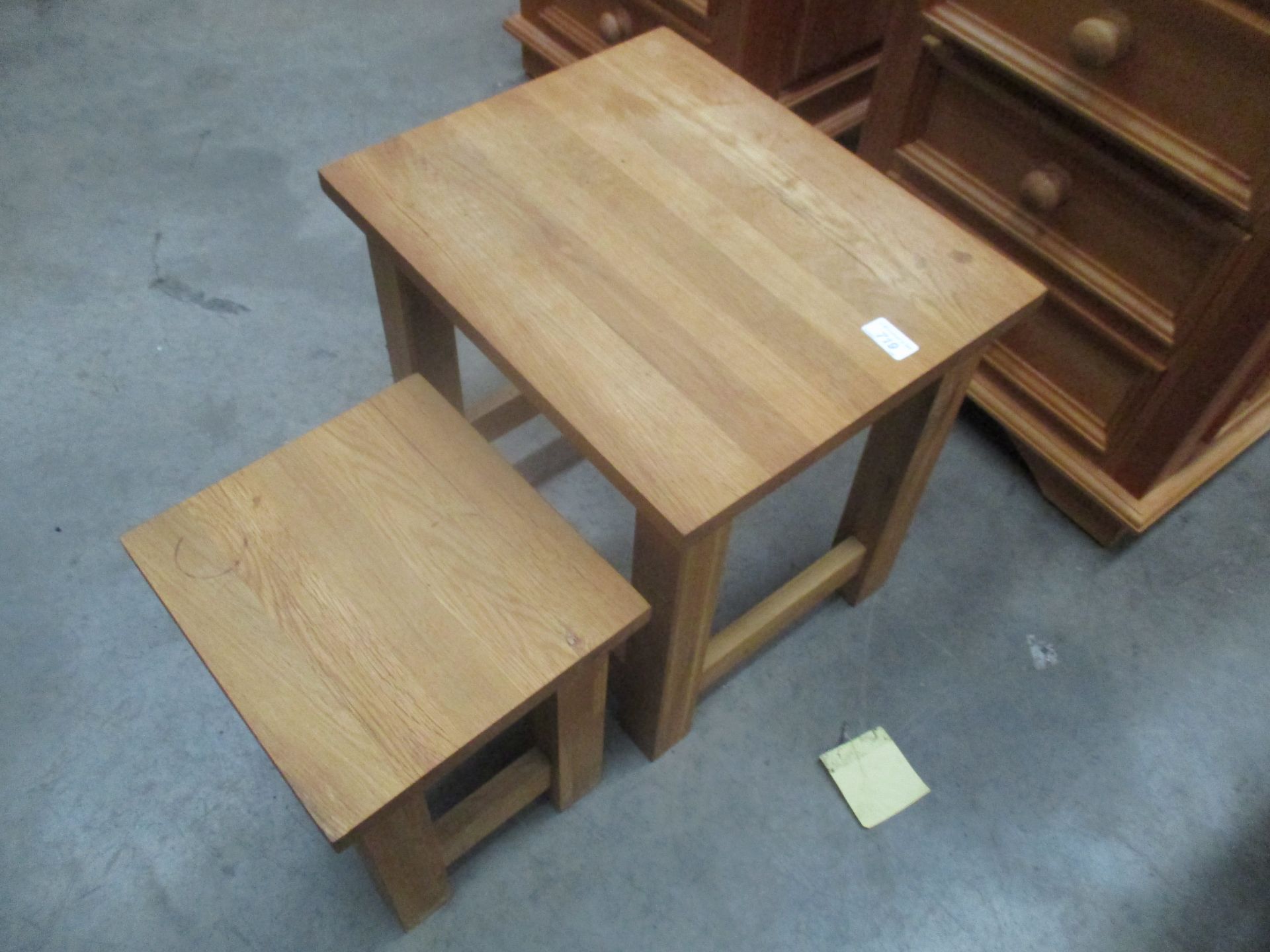 A light oak nest of two tables