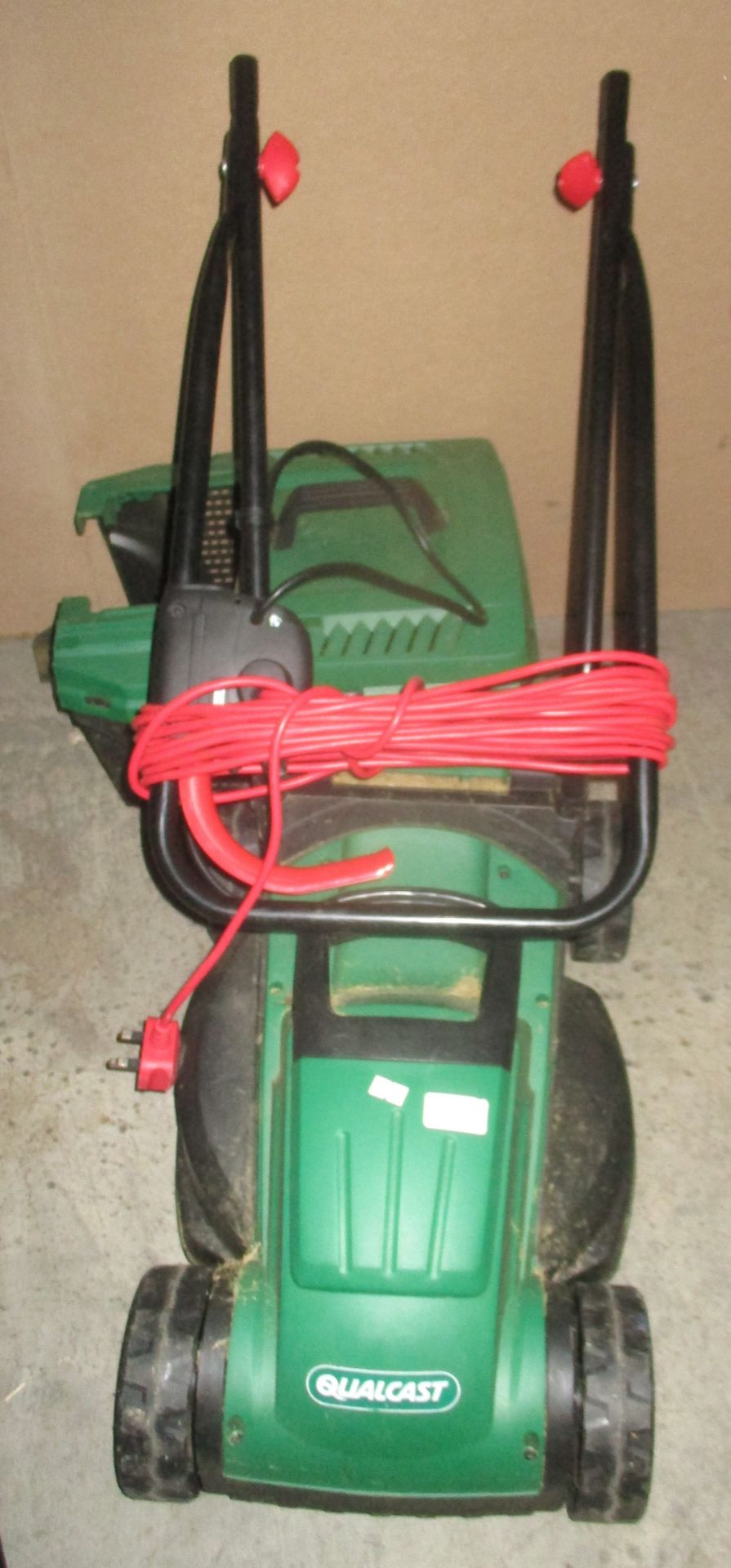 A Qualcast electric lawn mower complete with bucket