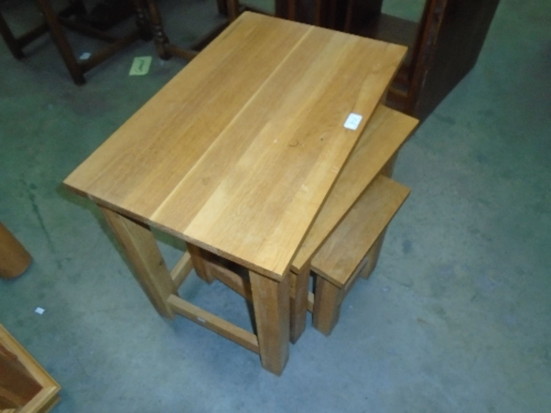 A light oak nest of three tables