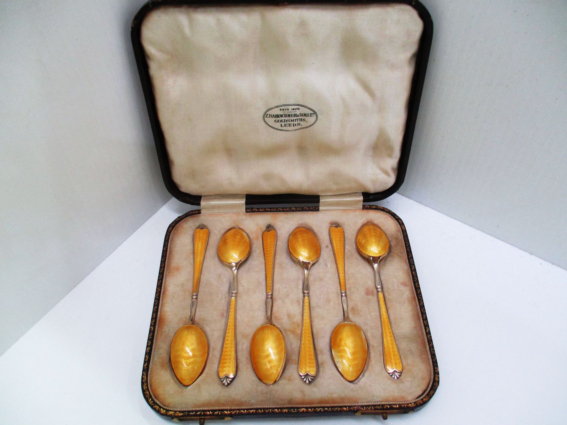 A set of six silver gilt coffee spoons with enamel decoration by Adie Bros Birmingham 1928 (2.