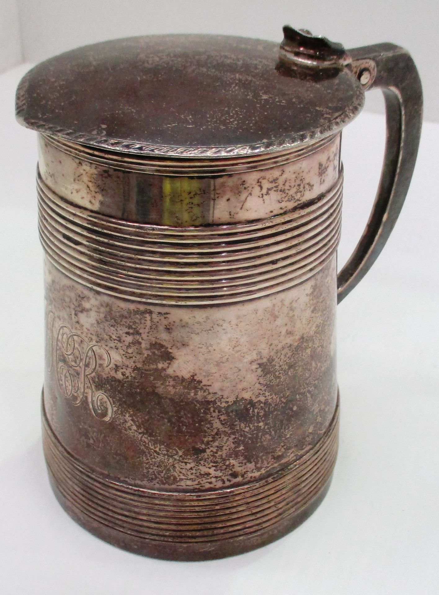 A late George III silver pint mug, decorated with raised reeded bands engraved cursive initials,