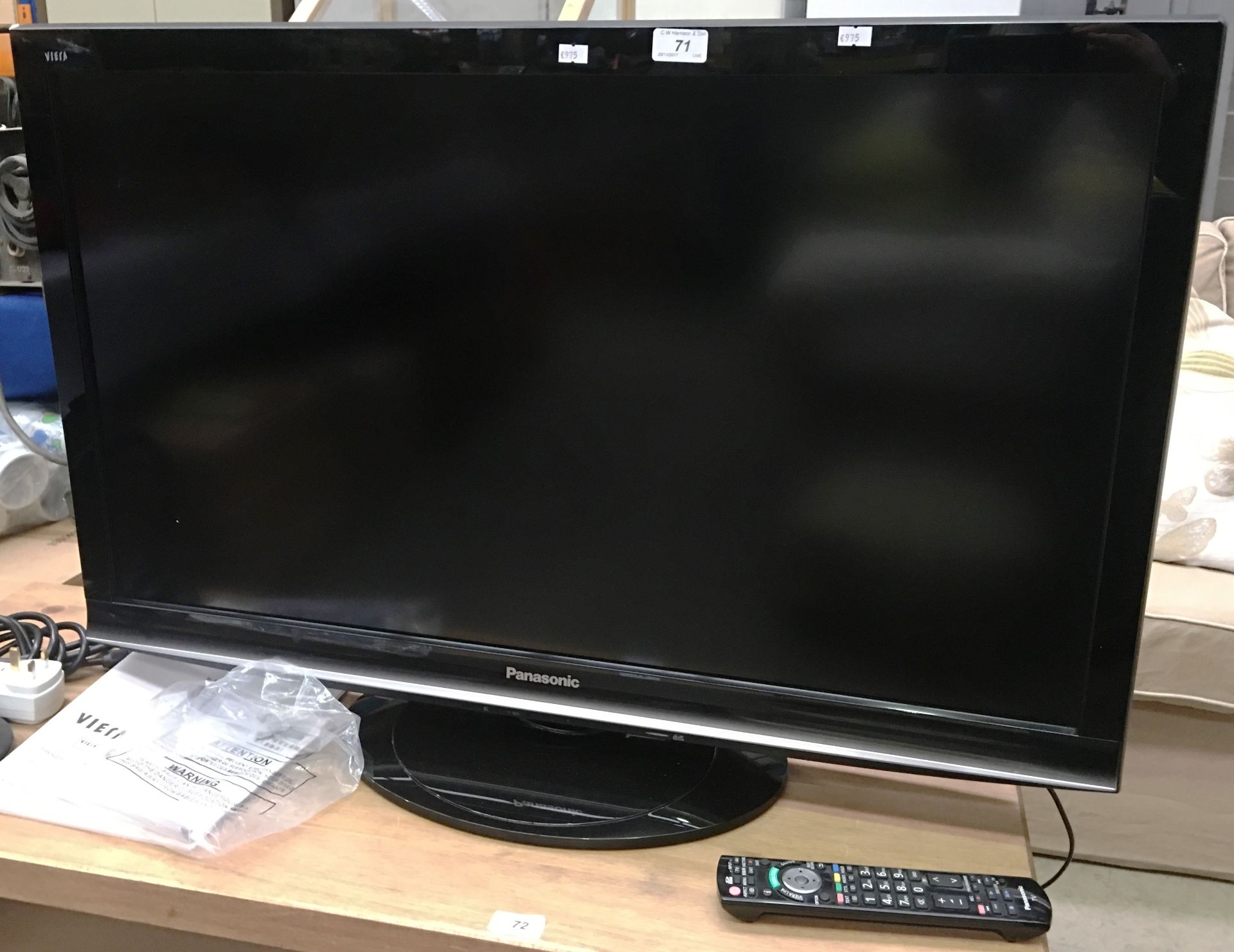A Panasonic TX-L37G15B 37" LCD TV with power lead, remote control and manuals, and a Bush DVD player
