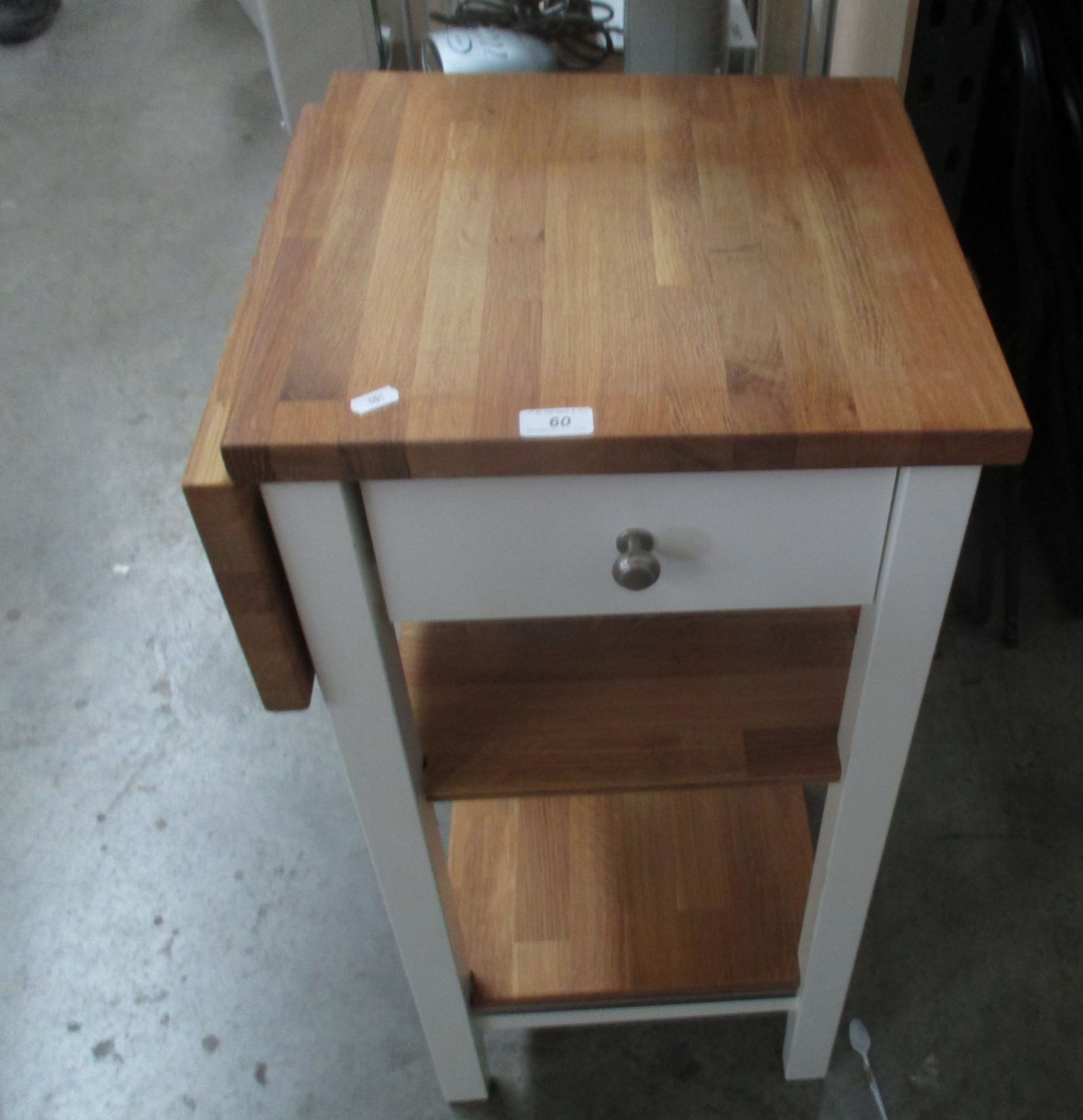 A mobile wooden single drawer kitchen chopping counter