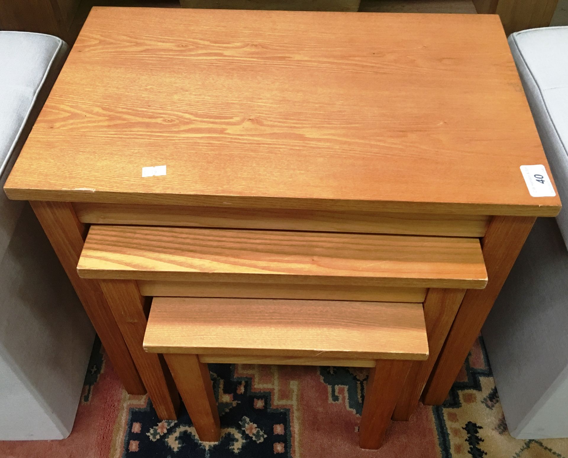 A light oak nest of three tables