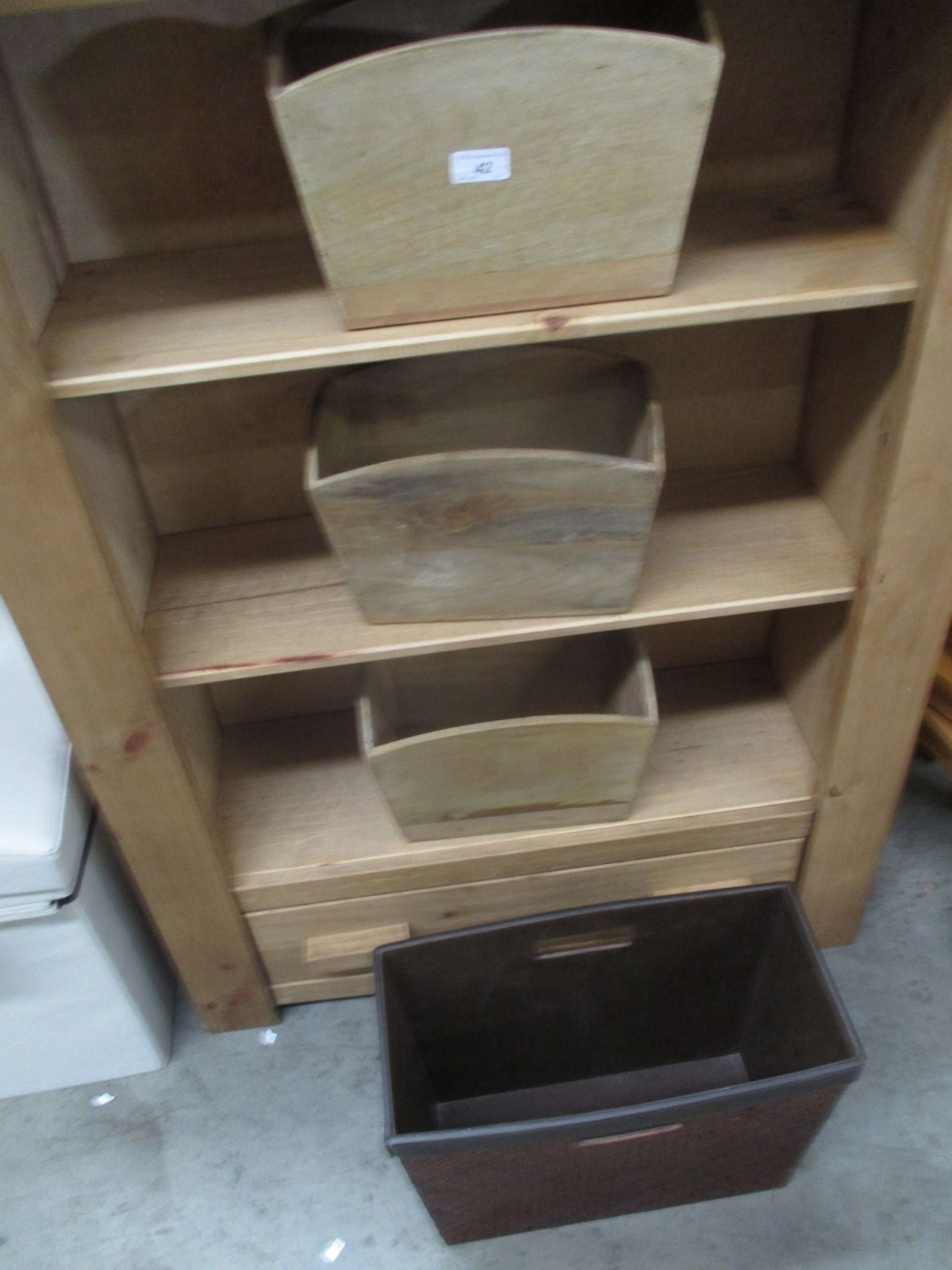 A brown leather finish magazine rack and three wooden storage units