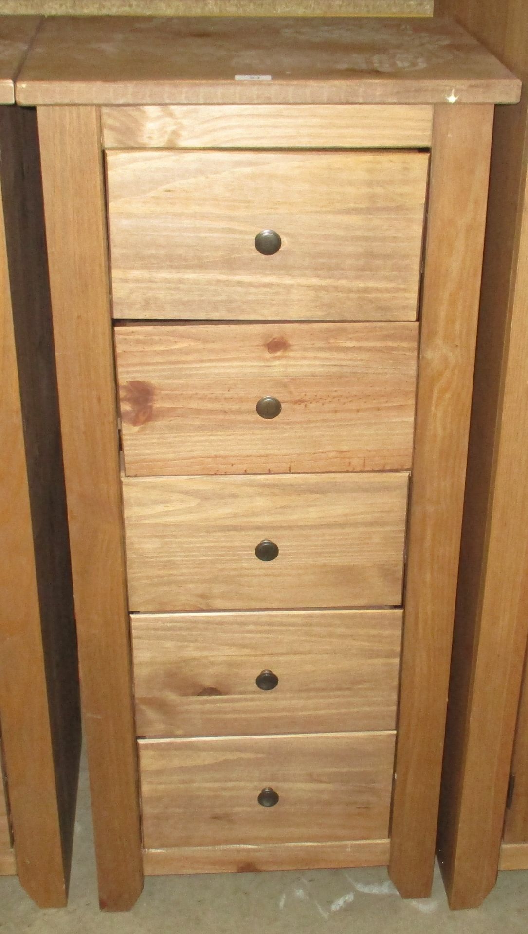 A modern stained pine finish five drawer tall boy 53 x 120cm