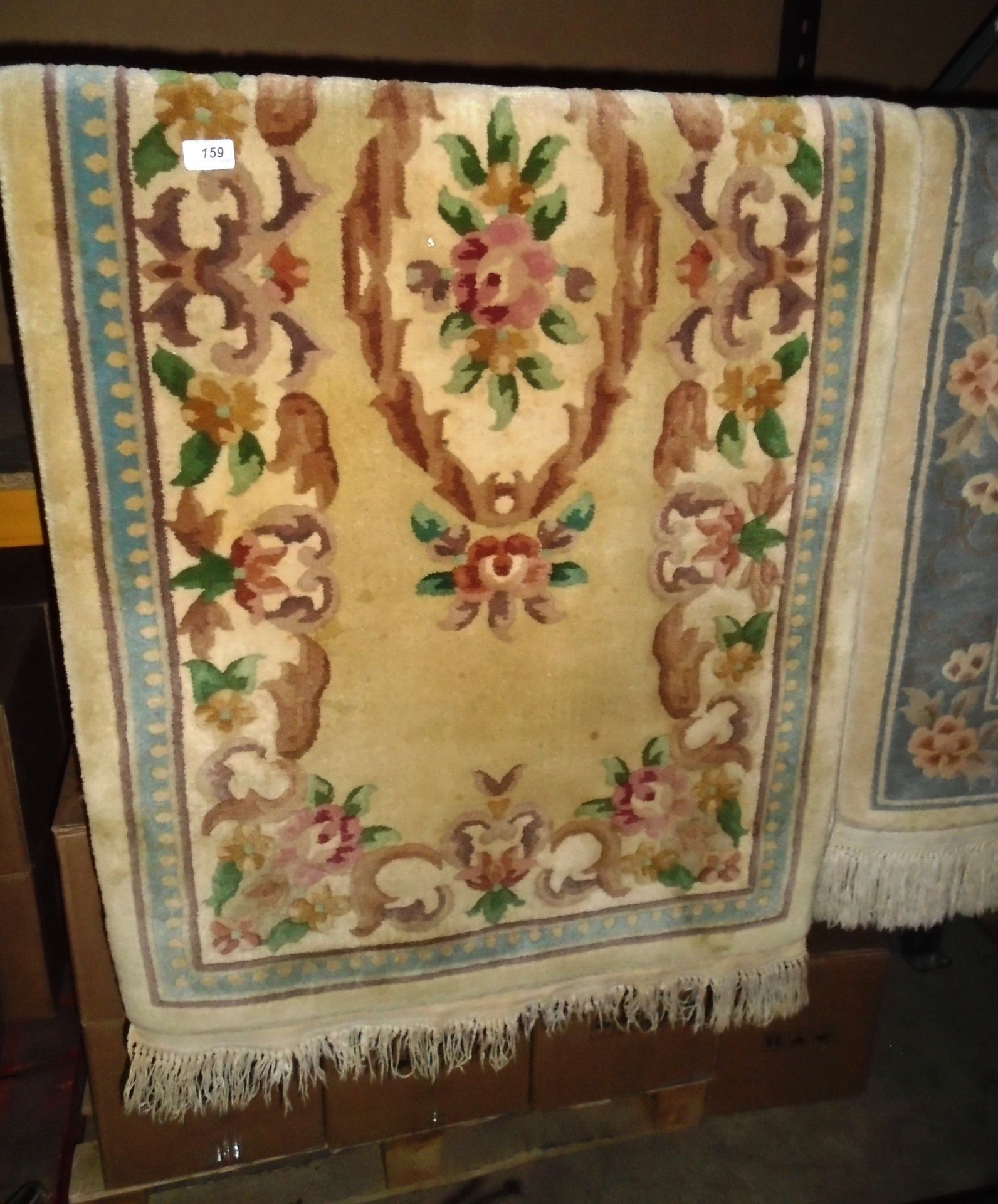 A beige patterned Chinese rug 78 x 152cm