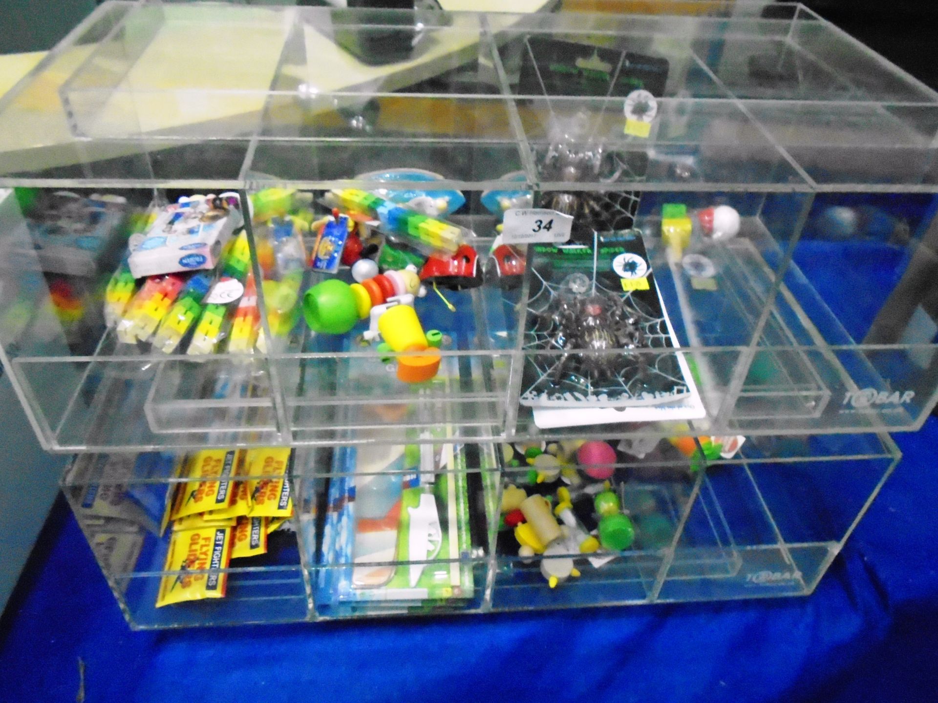 Contents to plastic display case - packs of flying gliders, window walker spiders, Twister blocks,