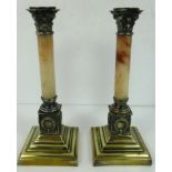 A pair of onyx and brass neoclassical style candlesticks on square stepped pedestal bases 23.