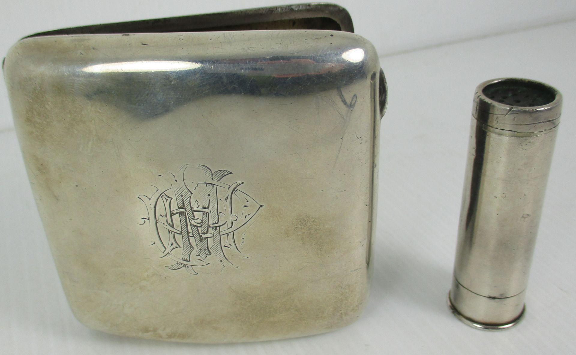 A squared silver cigarette case,