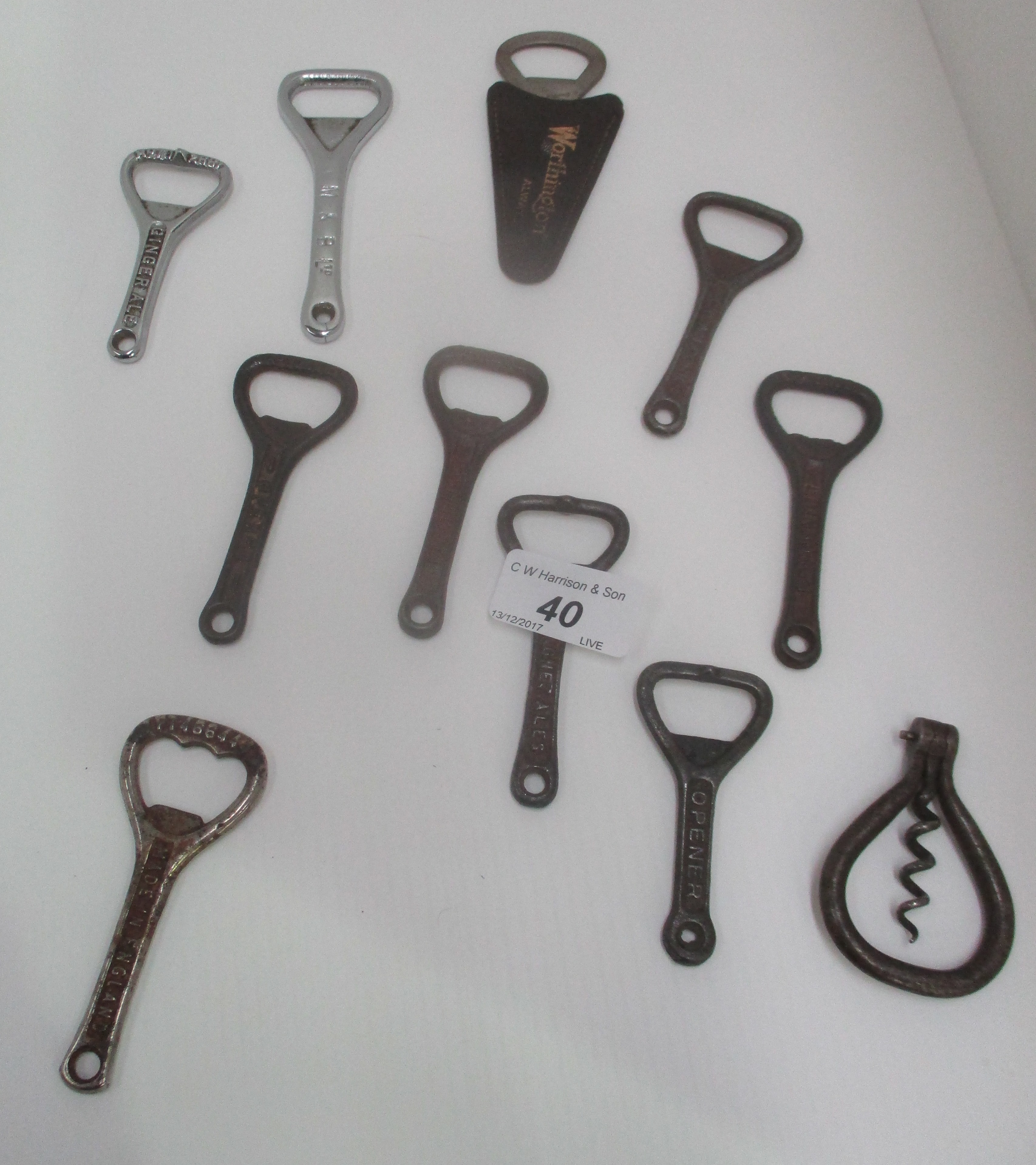 A collection of 11 metal bottle openers