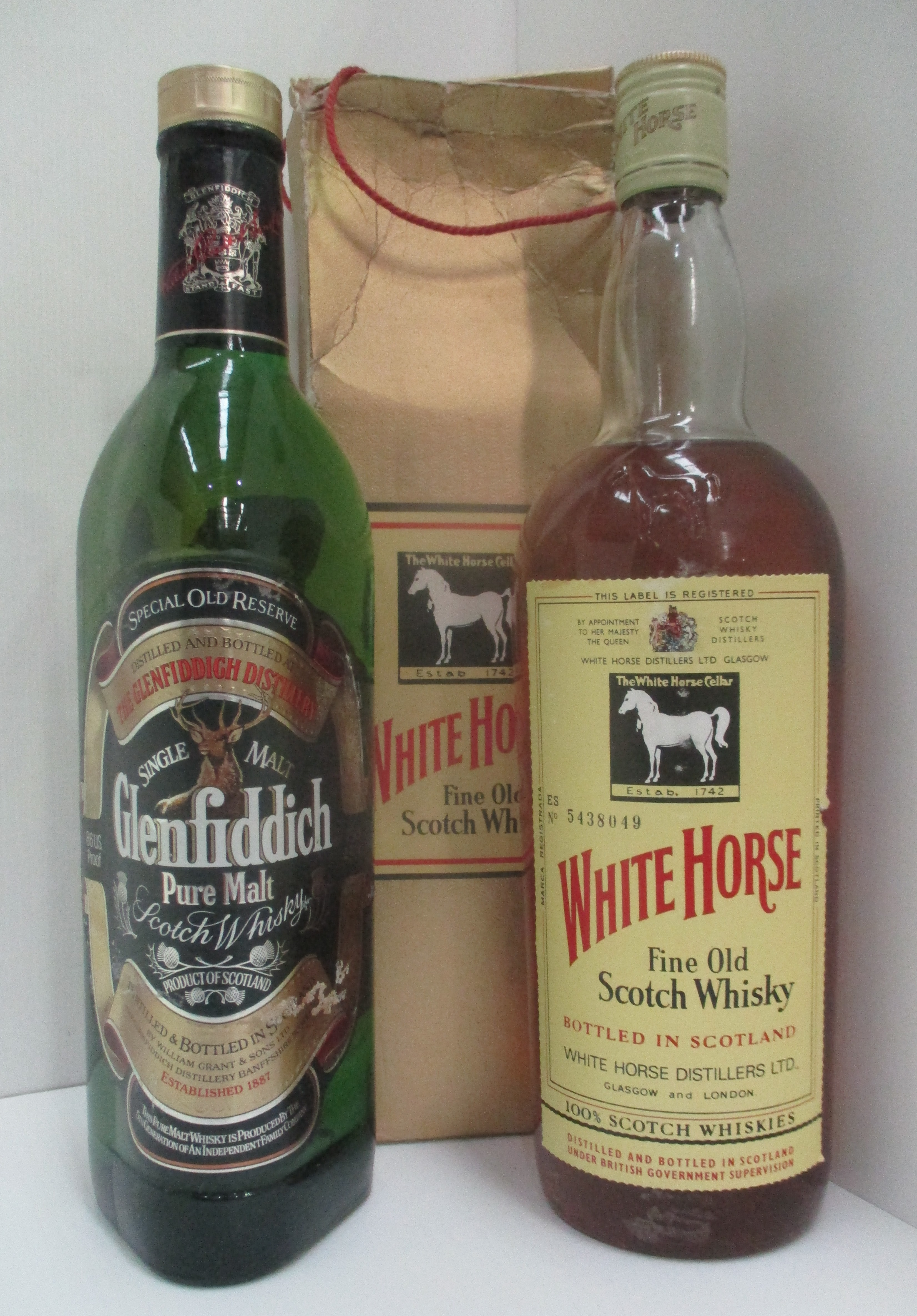 A one litre bottle of White Horse fine old Scotch Whisky in presentation box and a 75cl bottle of