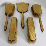 A five piece silver mounted dressing table set comprising two hairbrushes,