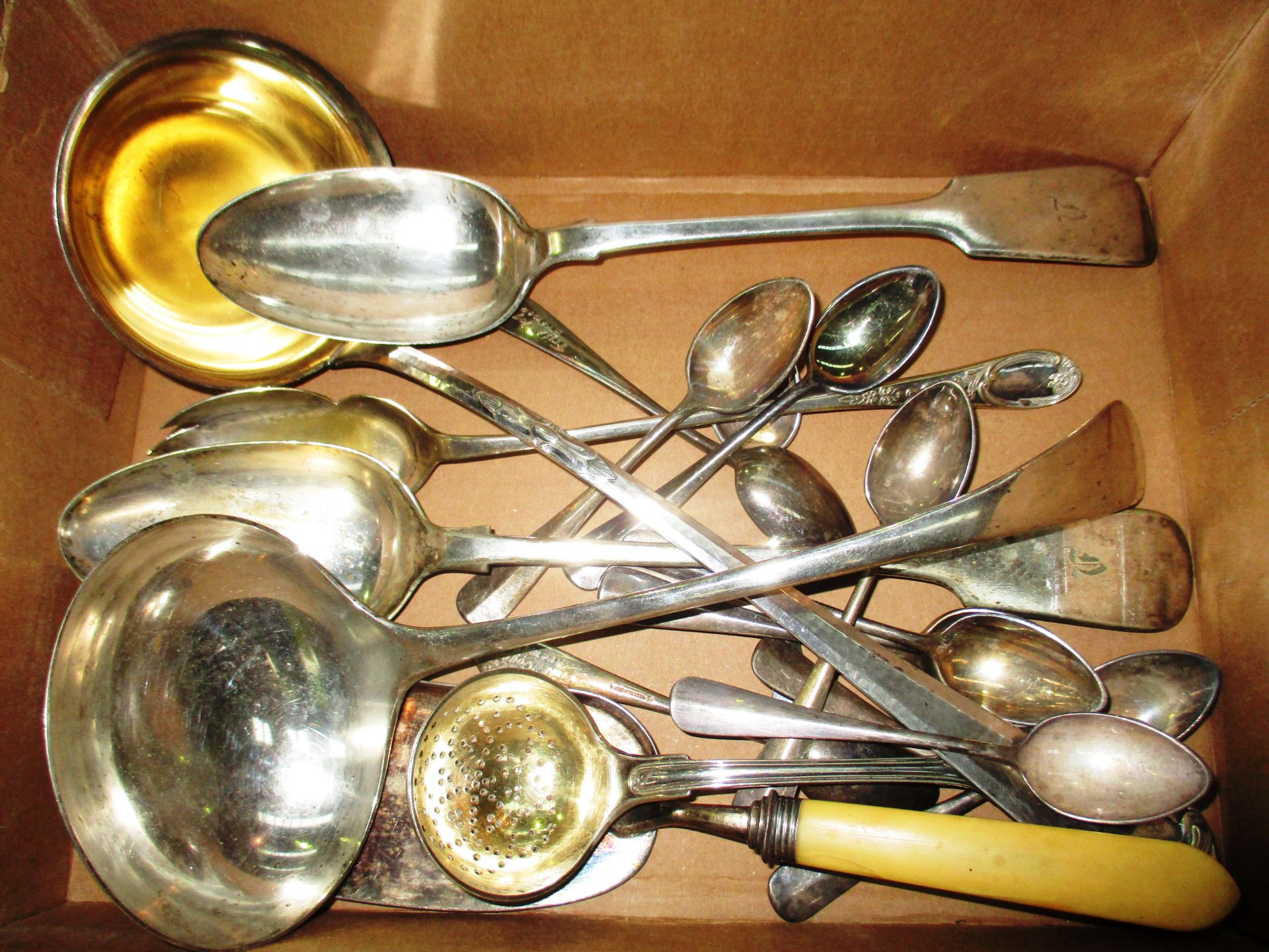 Assorted plated cutlery including ivory handled crumb scoop, two fiddle pattern serving spoons,
