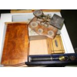 A pair of brass and wooden postal scales, a wooden money box, an optical tool, a wooden box,