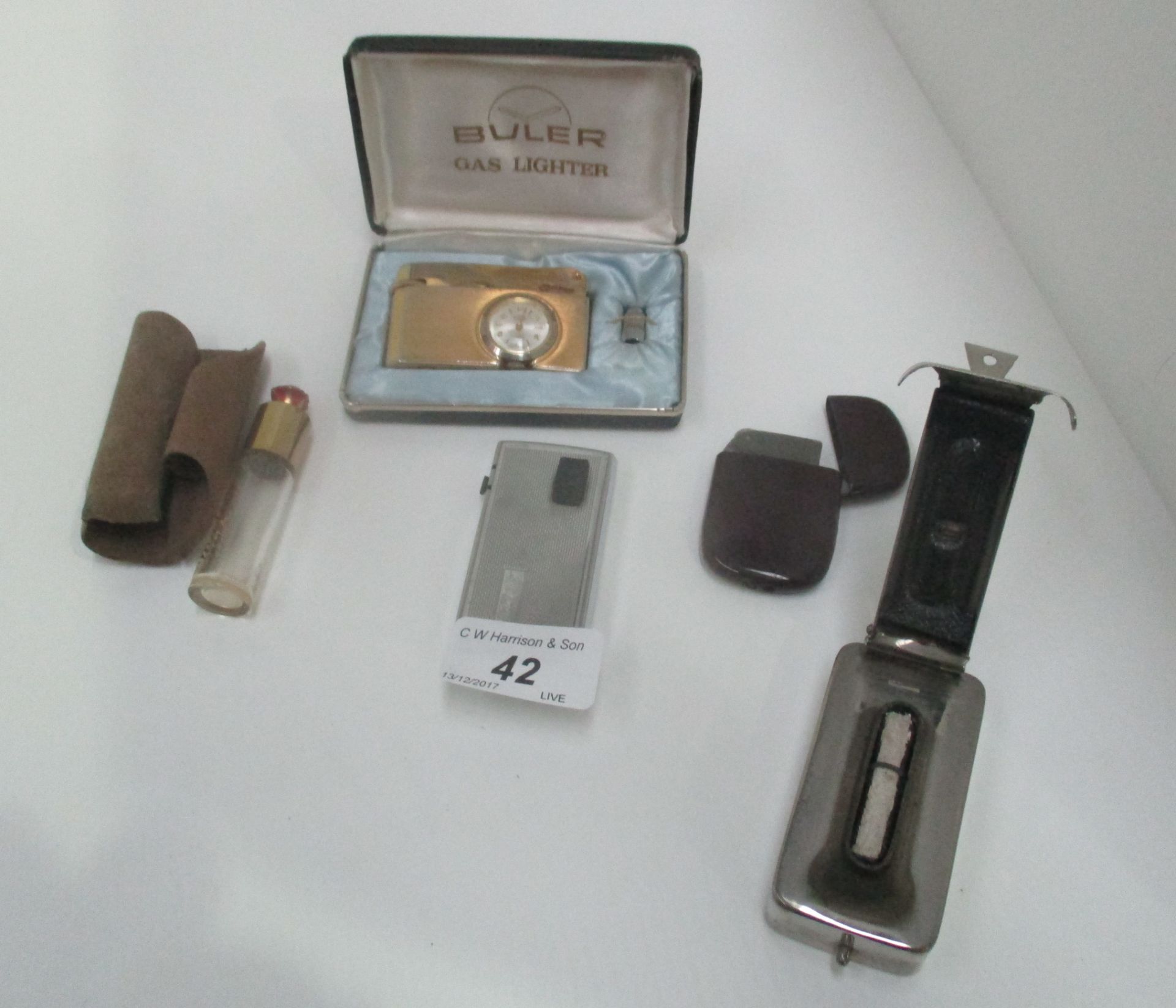 A Ronson lighter, a Buler gas lighter in box, a lighter in a bakelite case,