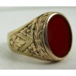 A gents signet ring with engraved decoration and red stone (no Hallmarks)