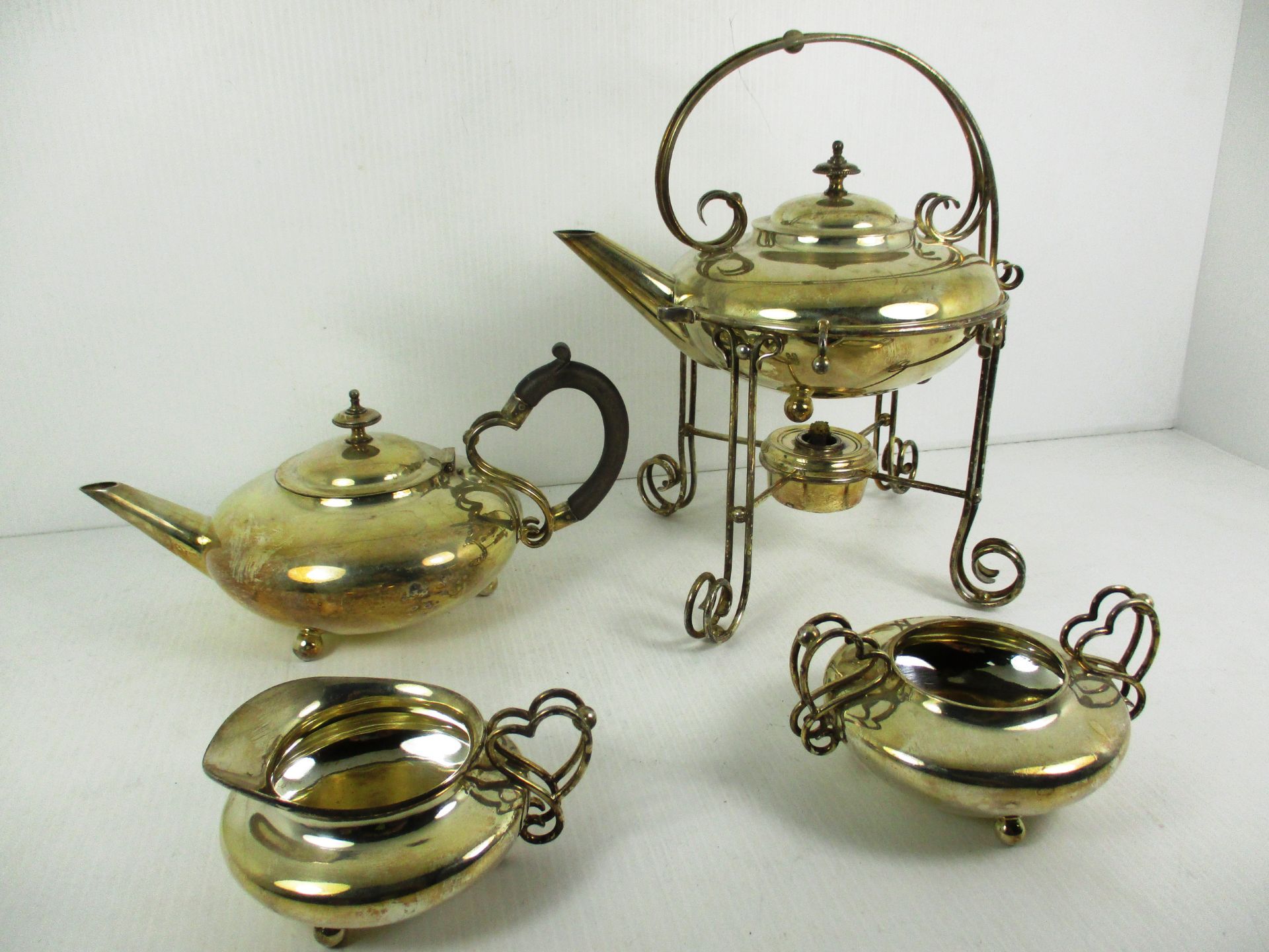 A four piece silver plated Art Nouveau style service comprising of spirit kettle on stand, teapot,