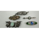 Five assorted silver brooches - one with angels flanking an opal stone,