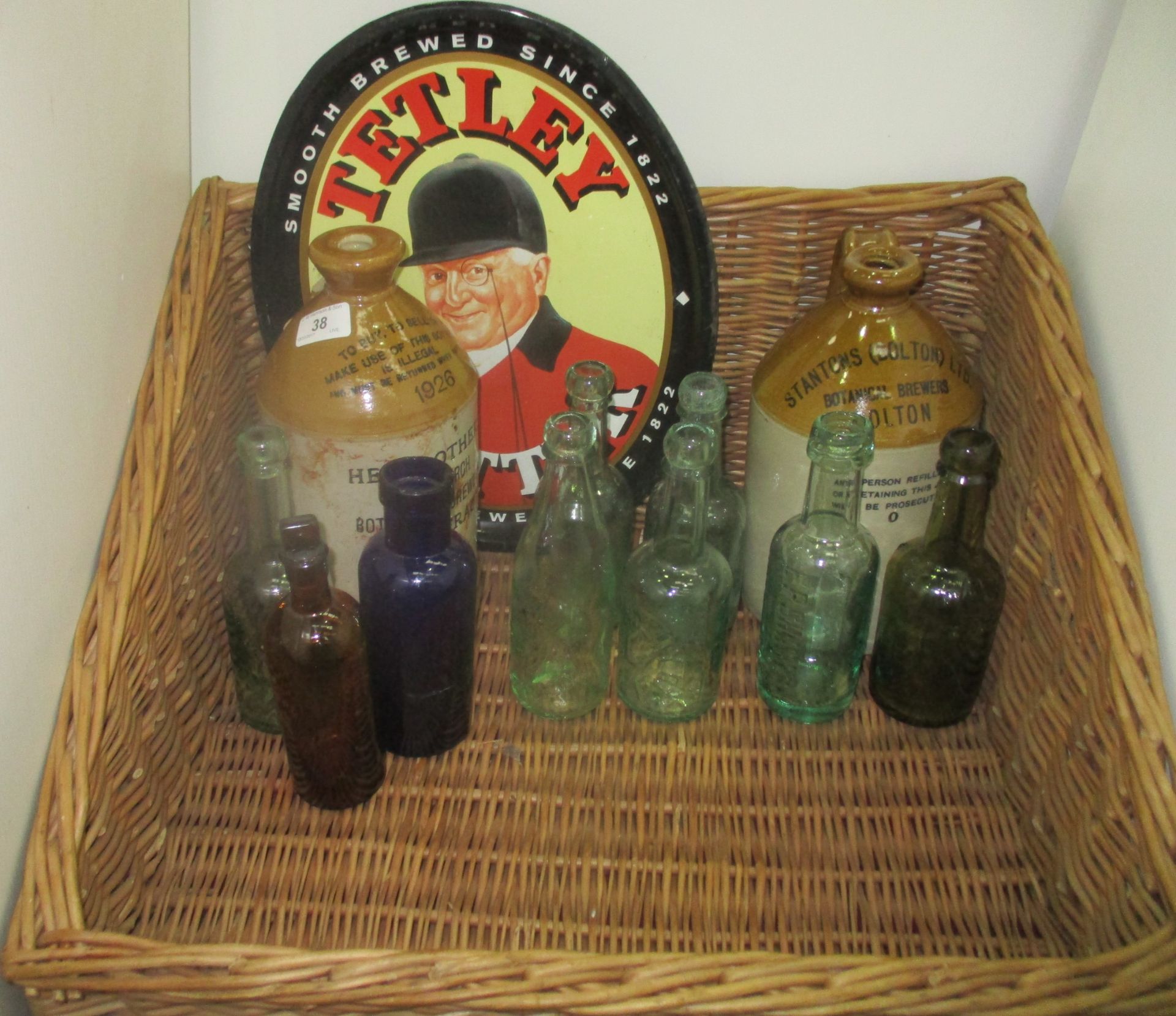 A wicker basket containing a Tetley beer tray,