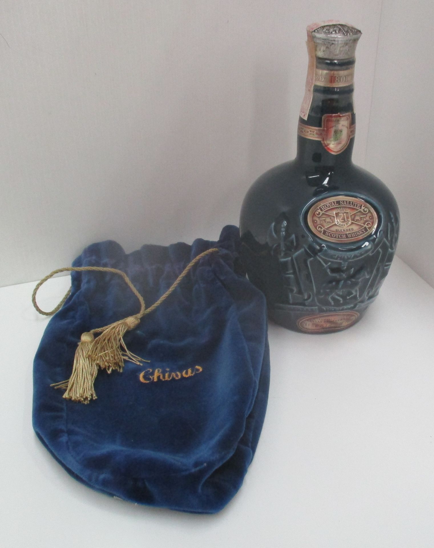 A 75cl Spode blue pottery liqueur bottle containing 26 2/3 fl.oz/75.