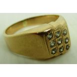 A gents ring set with 9 Brilliant stones (marked 585) (total approx weight 7.