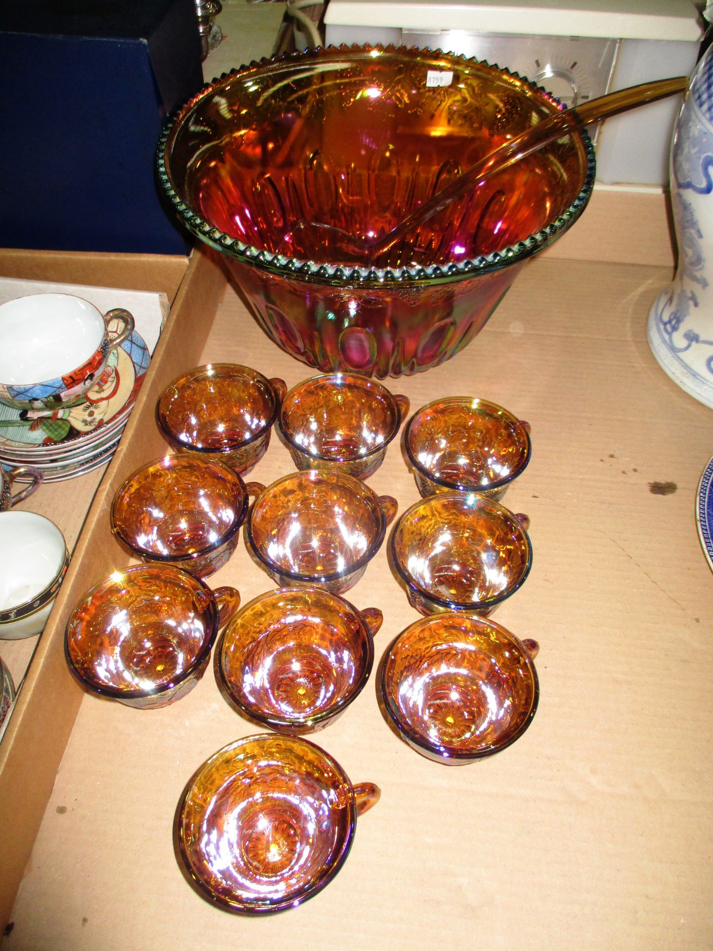 An Iridescent Carnival glass punch bowl and ladle with 10 x matching cups